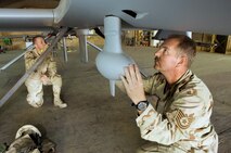 BALAD AIR BASE, Iraq (AFPN) - Tech. Sgt. James Moffett (right) and Airman 1st Class Dathen Schori inspect an unmanned aerial vehicle. Sergeant Moffett is a UAV crew chief and Airman Schori is an avionics specialist with the 332nd Expeditionary Aircraft Maintenance Squadron's Aircraft Maintenance Unit. (U.S. Air Force photo by Master Sgt. John E. Lasky)