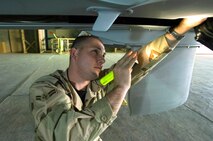 BALAD AIR BASE, Iraq (AFPN) -- Airman 1st Class Dathen Schori inspects an unmanned aerial vehicle. Airman Schori is an avionics specialist with the 332nd Expeditionary Aircraft Maintenance Squadron's Aircraft Maintenance Unit. (U.S. Air Force photo by Master Sgt. John E. Lasky)