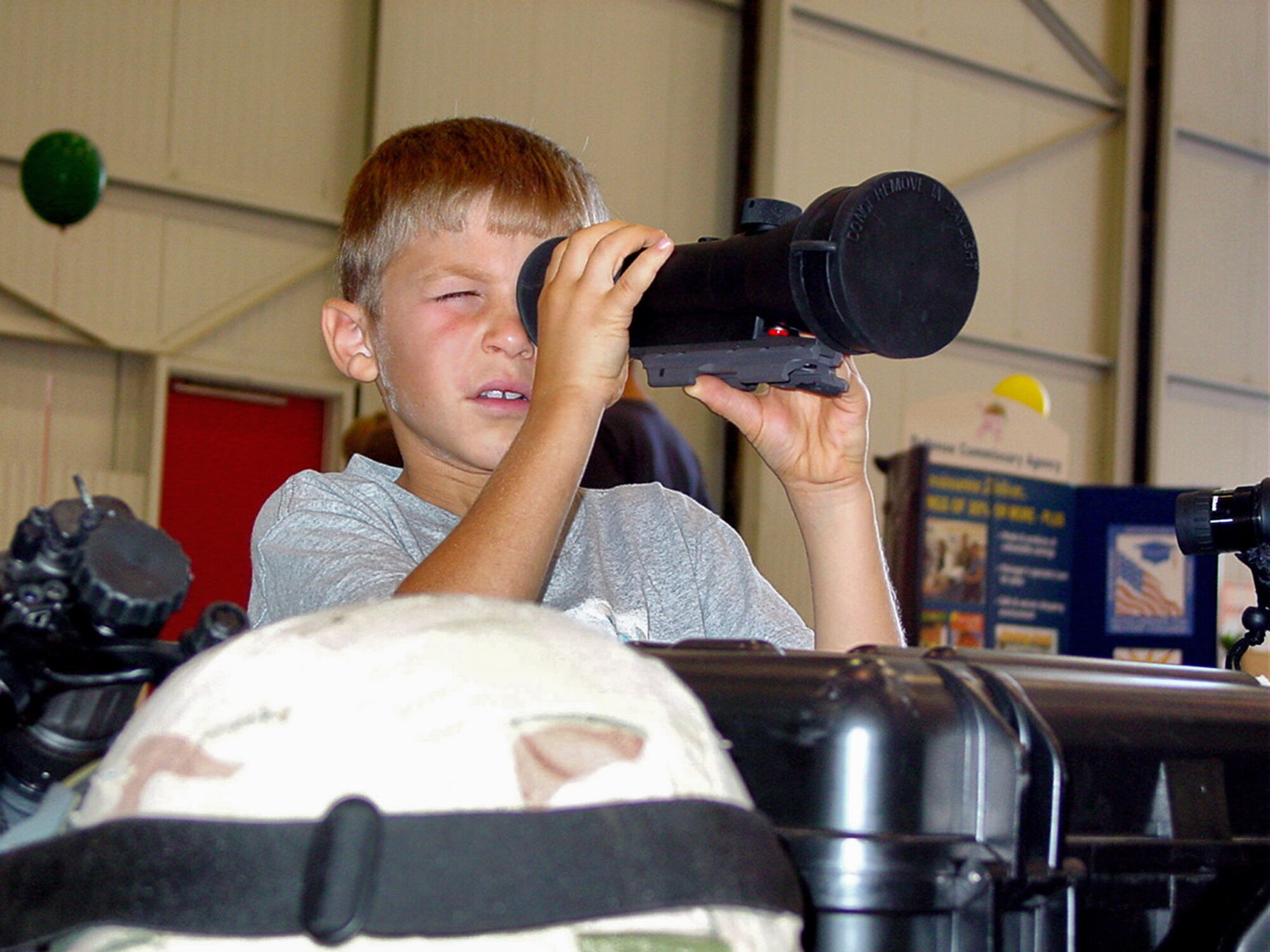 BEALE AIR FORCE BASE, Calif. (AFPN) -- Joshua Pelletier looks through a scope at a display in during military family day here. (U.S. Air Force photos by Airman 1st Class Christine Byers)
