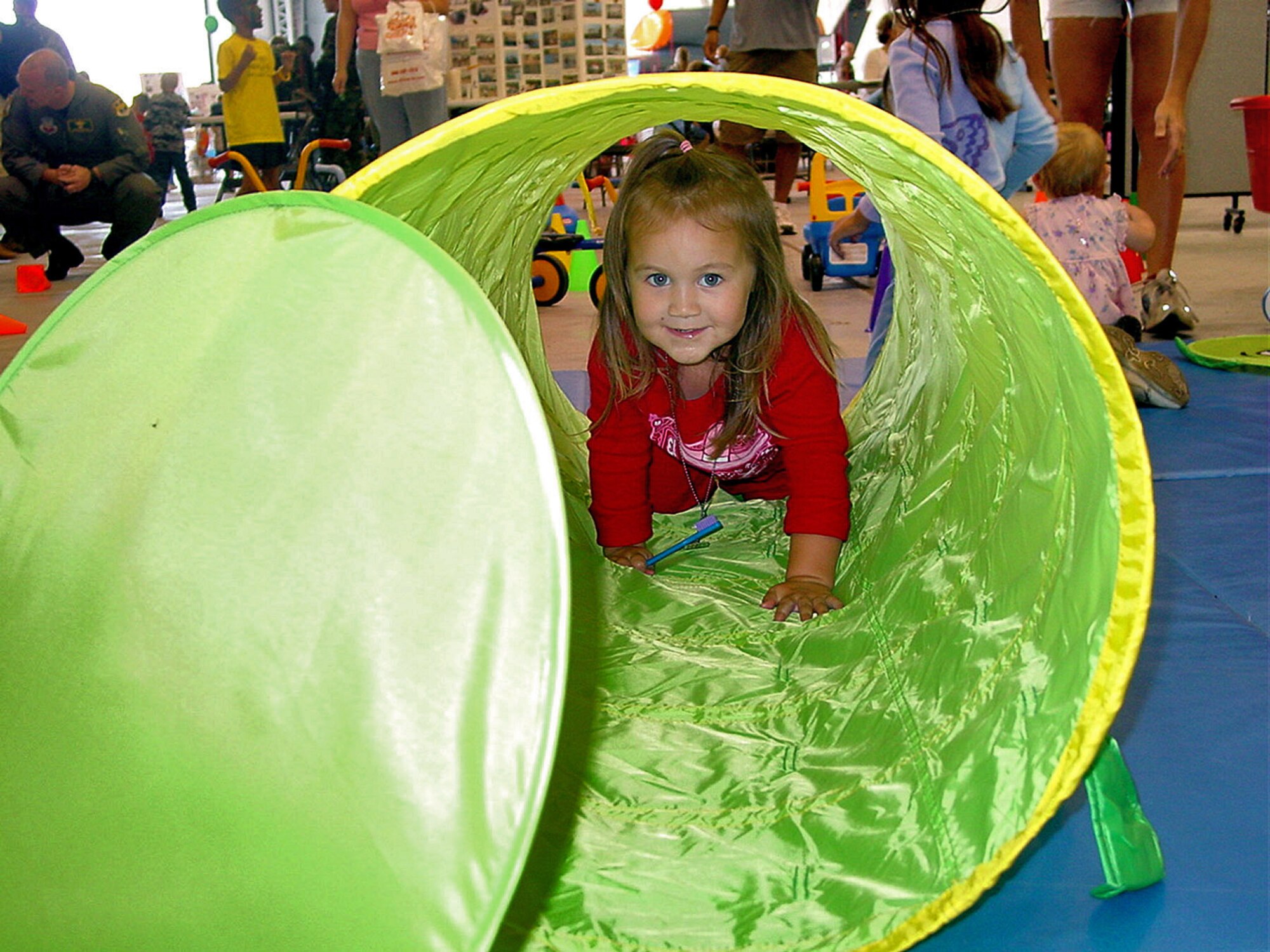 BEALE AIR FORCE BASE, Calif. -- Molly Griego crawls through a tunnel in the kids play area during Beales Military Family Day. (U.S. Air Force photos by Airman 1st Class Christine Byers)