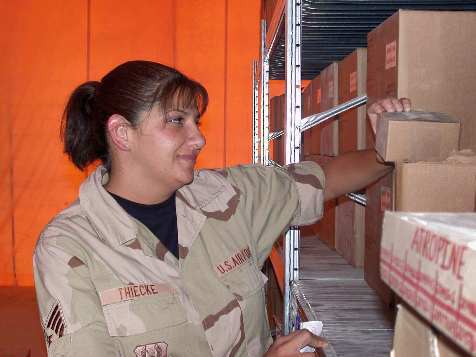 SOUTHWEST ASIA (AFPN) -- Staff Sgt Tamara Thiecke, 379th Expeditionary Medical Squadron medical logistics NCO in charge of medical war reserve materiels, checks the lot number on a medical item. The 379th EMEDS medical logistics flight maintains more than $200,000 worth of medical supplies. (U.S. Air Force photo by Staff Sgt. Alicia Prakash) 