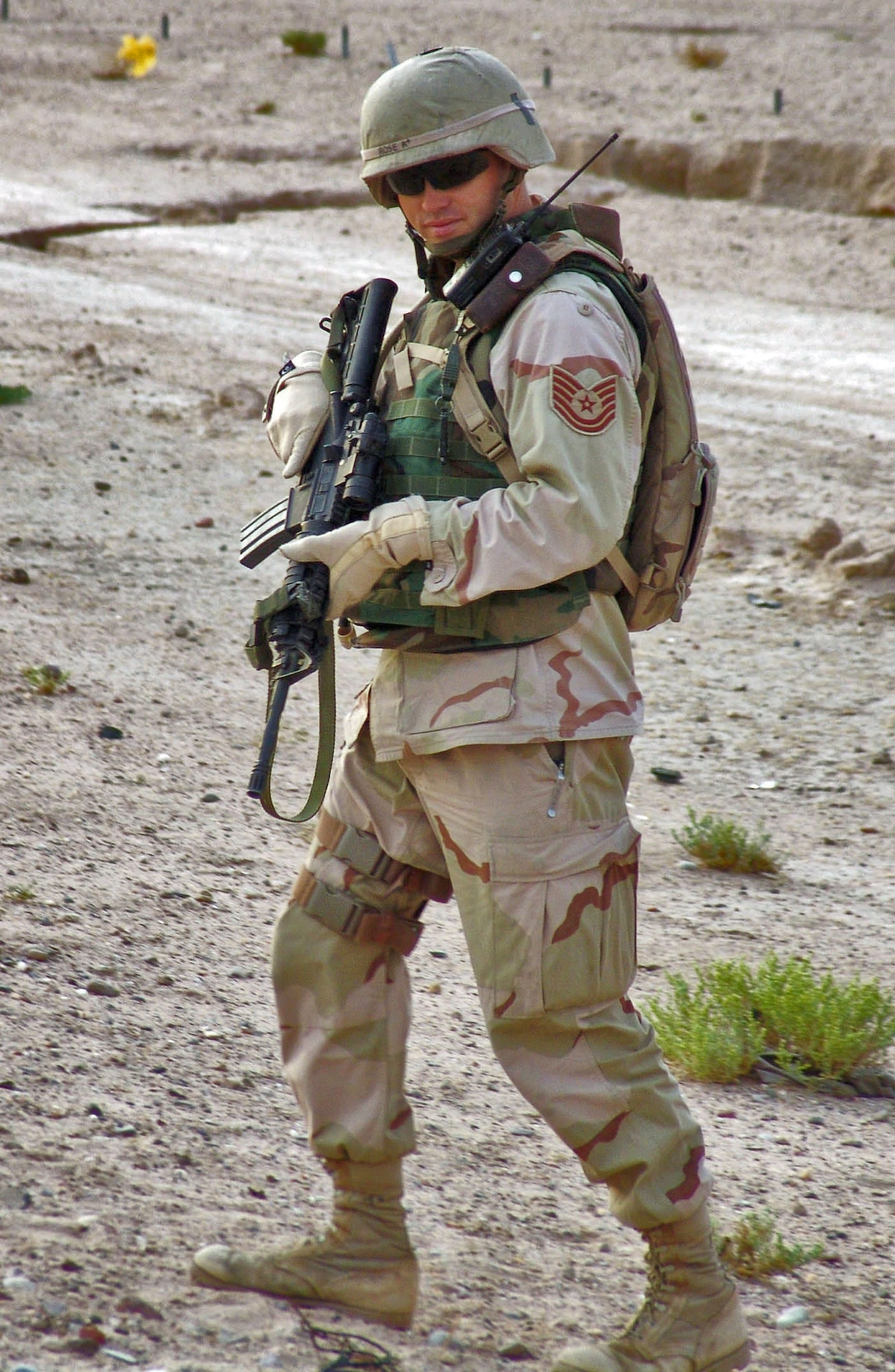 CAMP BUCCA, Iraq -- Tech Sgt. Robert Rose, a 586th Expeditionary Security Forces Squadron security forces member, checks a roadside culvert for improvised explosive devices. The 586th ESFS provides base and area security and convoy escorts here. (U.S. Air Force photo by Capt. Michael G. Johnson) 
