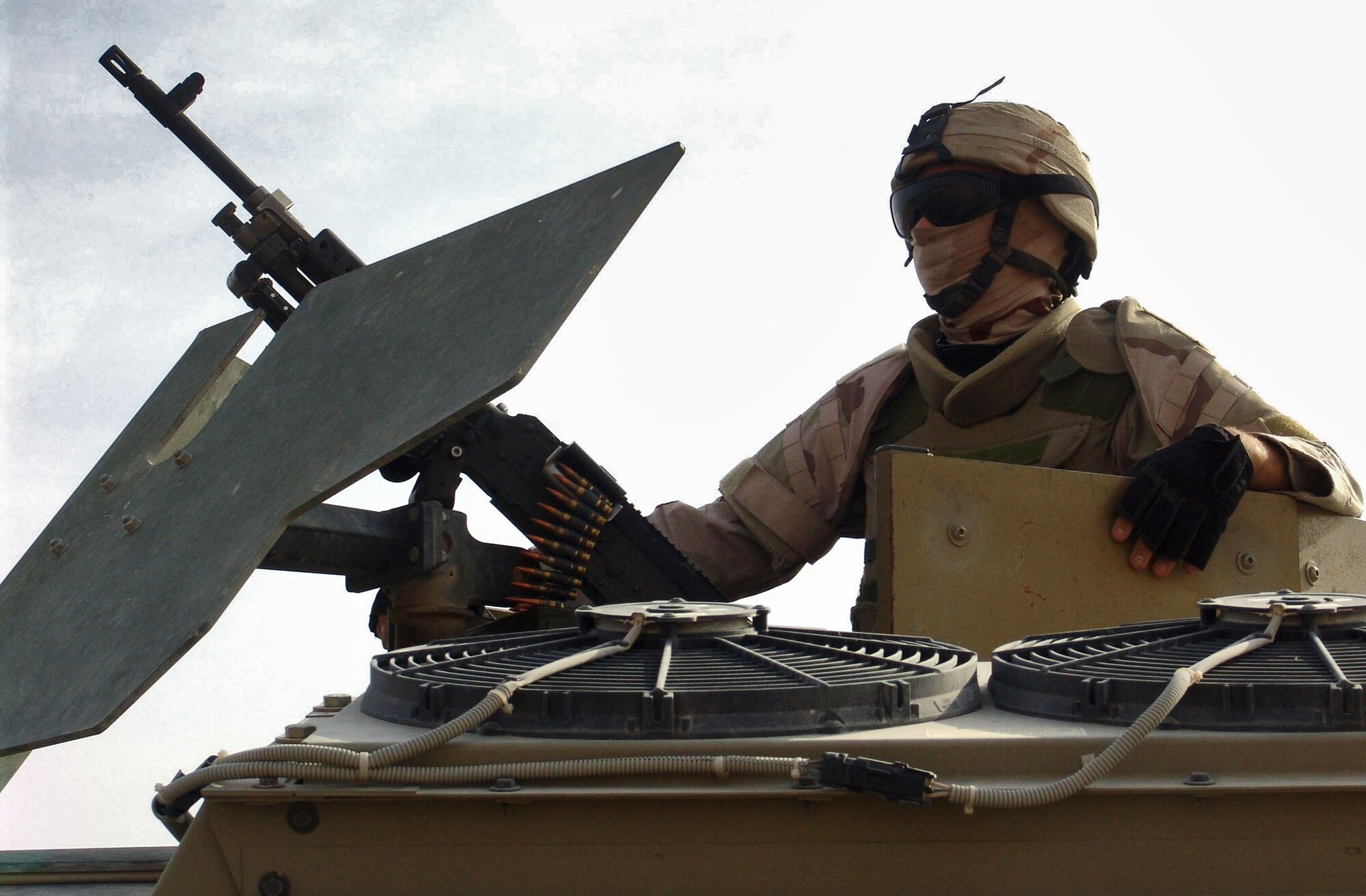 CAMP BUCCA, Iraq (AFPN) -- Airman 1st Class Samuel Hicks, a 586th Expeditionary Security Forces Squadron security forces member, scans the roadside and horizon from the gun turret of his vehicle. The 586th ESFS provides base and area security and convoy escorts here. (U.S. Air Force photo by Capt. Michael G. Johnson) 