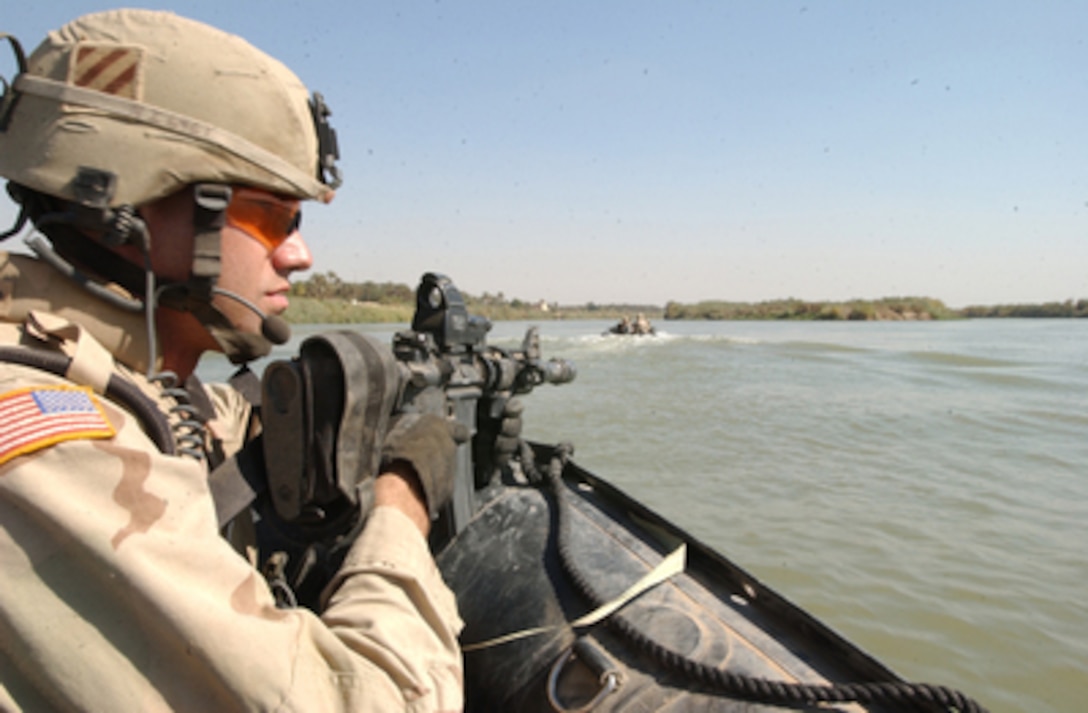Soldiers with the 3rd Battalion, 7th Cavalry, 3rd Infantry Division patrol by boat on the Tigris River in Baghdad, Iraq, on Oct. 21, 2005. The soldiers will search islands on the Tigris for insurgent activity and weapons caches. 