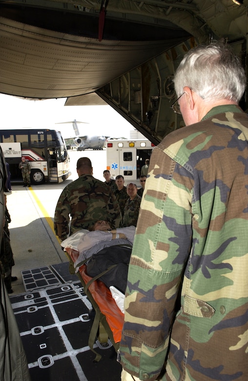 ANDREWS AIR FORCE BASE, Md. - A passenger is carried from a C-130 Hercules after Airmen with the 908th Airlift Wing at Maxwell Air Force Base, Ala., the 375th Aeromedical Evacuation Squadron at Scott AFB, Ill., and the 89th Medical Group here transported veterans from the Armed Forces Home in Gulfport, Miss., after Hurricane Katrina decimated the area. The veterans were flown by a C-130 Hercules from Maxwell to here where they were then taken to the Armed Forces Home in Washington, D.C. (U.S. Air Force photo by Staff Sgt. Christopher J. Matthews)