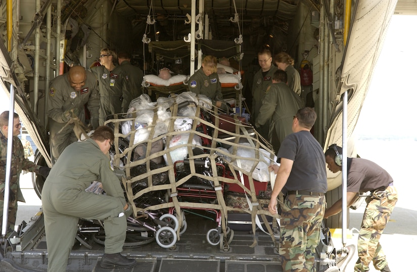 ANDREWS AIR FORCE BASE, Md. -- Airmen with the 908th Airlift Wing at Maxwell Air Force Base, Ala., the 375th Aeromedical Evacuation Squadron at Scott AFB, Ill., and the 89th Medical Group here strap down cargo while transporting veterans from the Armed Forces Home in Gulfport, Miss., after Hurricane Katrina decimated the area. The veterans were flown by a C-130 Hercules from Maxwell to here where they were then taken to the Armed Forces Home in Washington, D.C. (U.S. Air Force photo by Staff Sgt. Christopher J. Matthews)