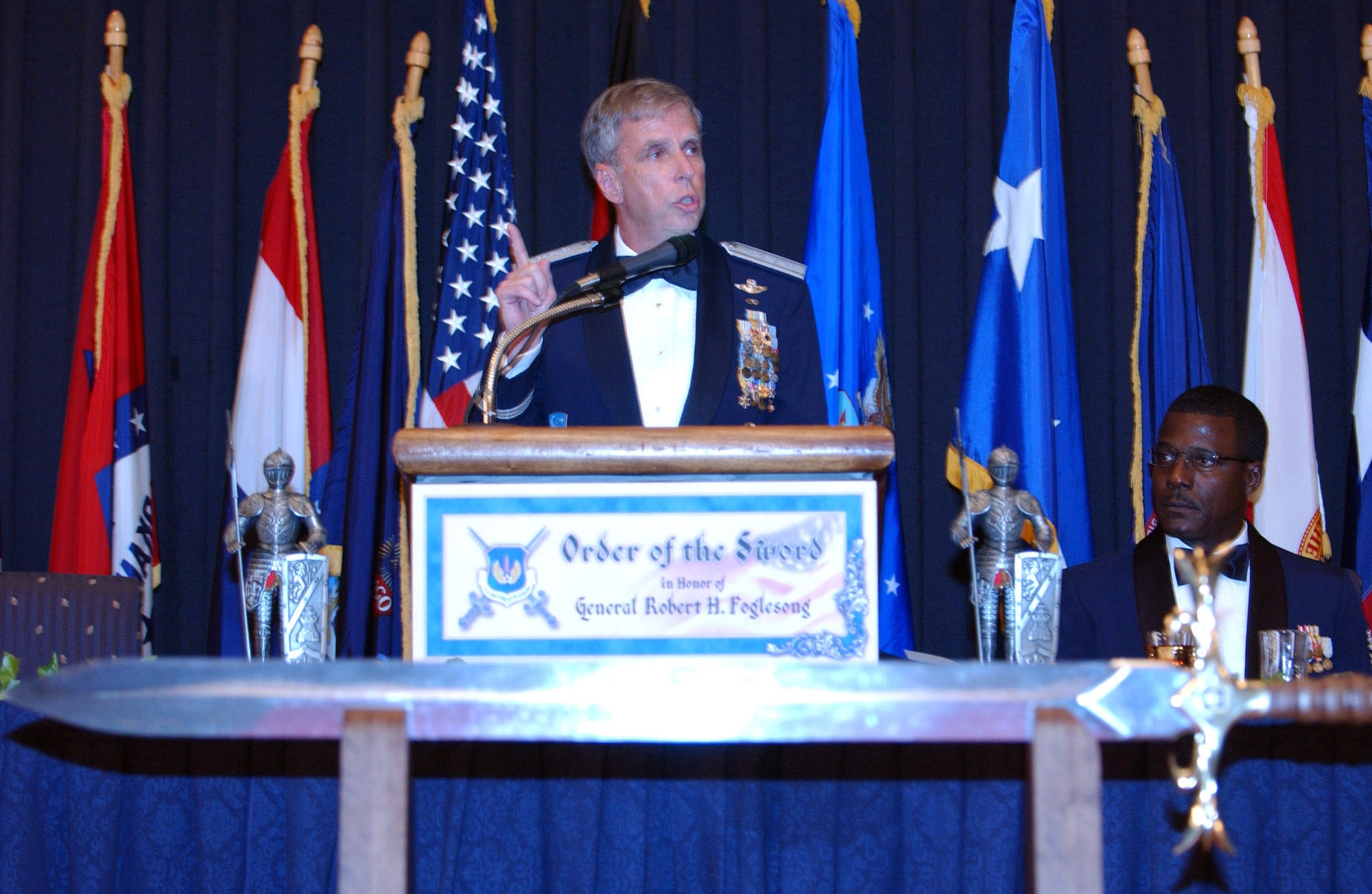 RAMSTEIN AIR BASE, Germany -- Gen. Robert H. "Doc" Foglesong thanks the U.S. Air Forces in Europe enlisted corps for his induction into the Order of the Sword on Aug. 26, as Chief Master Sgt. Gary Coleman looks on.  General Foglesong is the USAFE commander, and Chief Coleman is the USAFE command chief master sergeant.  (U.S. Air Force photo by Airman 1st Class Megan Carrico)