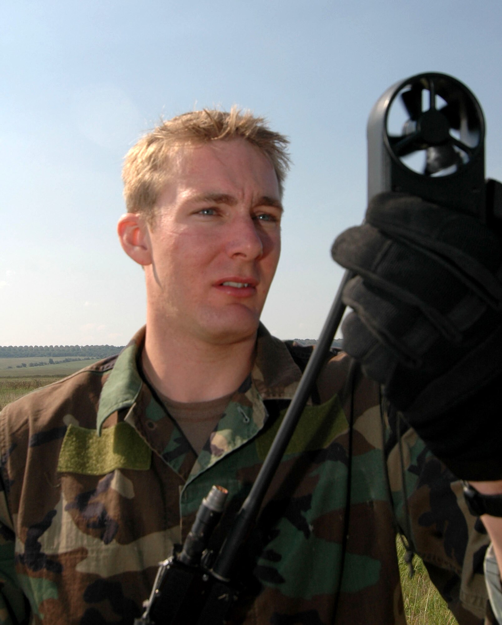 PLOVDIV, Bulgaria -- Senior Airman Kristopher Abel uses a wind indicator to gauge the weather for a landing site for two other pararescuemen. He is one of about 50 56th Rescue Squadron Airmen from Naval Air Station Keflavik, Iceland, who are here for exercise Cooperative Key 05. (U.S. Air Force photo by Tech. Sgt. Chance Babin)