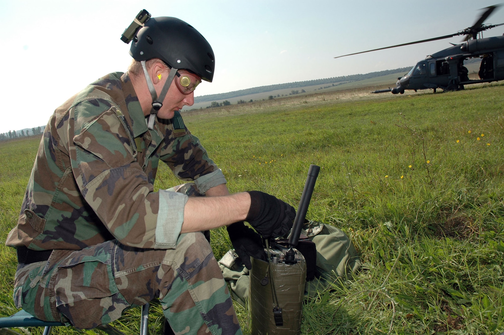 PLOVDIV, Bulgaria -- Senior Airman Kristopher Abel sets up a radio while preparing a landing site for two other pararescuemen. He is one of about 50 56th Rescue Squadron Airmen from Naval Air Station Keflavik, Iceland, who are here for exercise Cooperative Key 05. (U.S. Air Force photo by Tech. Sgt. Chance Babin)