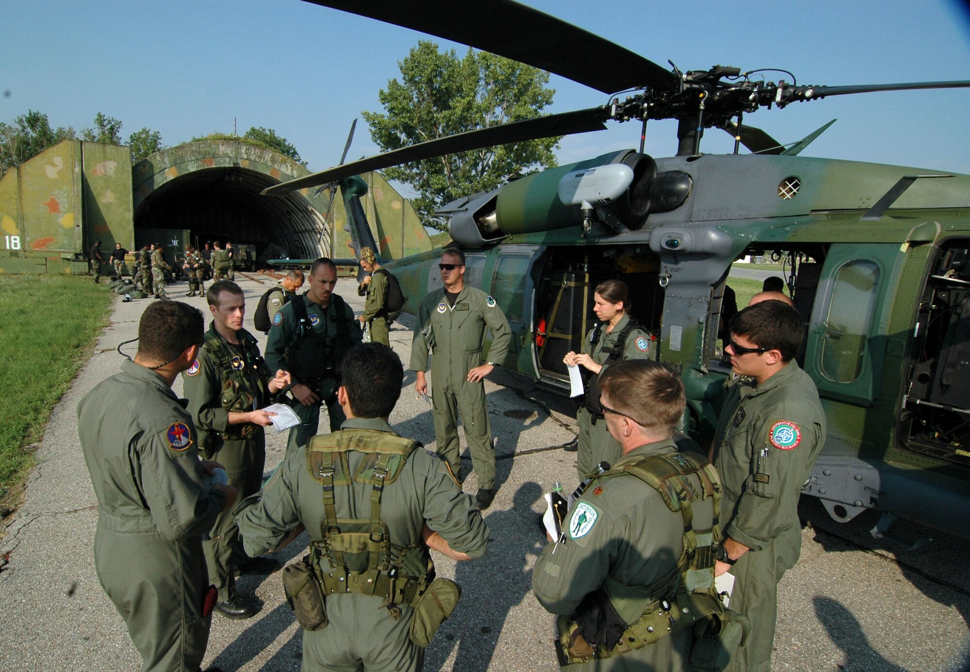 PLOVDIV, Bulgaria -- Capt. Matt Schexnyder briefs two crews before performing a parajump mission. He is one of about 50 56th Rescue Squadron Airmen from Naval Air Station Keflavik, Iceland, who are here for exercise Cooperative Key 05. He is an HH-60G Pave Hawk instructor pilot. (U.S. Air Force photo by Tech. Sgt. Chance Babin)