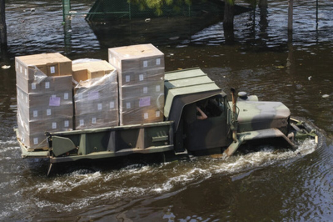 A National Guard multi-purpose utility truck fords the floodwaters left by Hurricane Katrina to bring supplies to the Super Dome in downtown New Orleans, La., on Aug 31, 2005. Tens of thousands of displaced citizens sought shelter at the dome but are now being evacuated as floodwaters continue to rise throughout the area. Department of Defense units are mobilizing as part of Joint Task Force Katrina to support the Federal Emergency Management Agency's disaster-relief efforts in the Gulf Coast areas devastated by Hurricane Katrina. 
