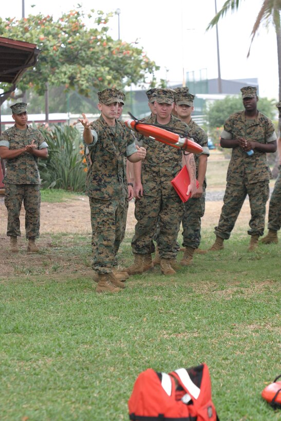 Lance Corporal Jonathan P. Hill, 24, headquarters  3rd Marines, tosses a life ring after being briefed on the proper techniques of throwing the ring. Marines were graded on how close their toss landed to the victim without hitting the victim.