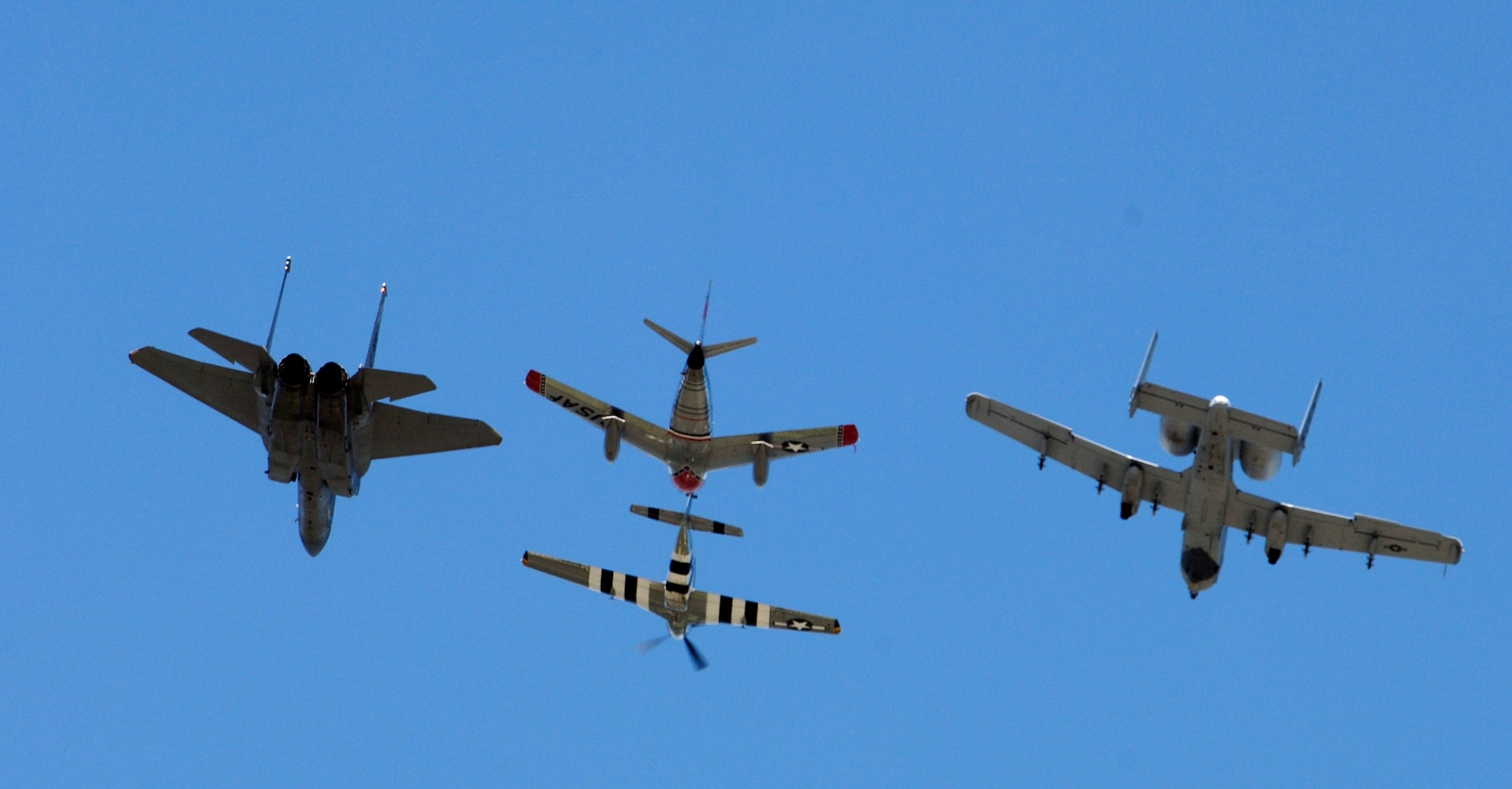 ANDREWS AIR FORCE BASE, Md. - A heritage flight consisting of an F-15 Eagle, an A-10 Thunderbolt II, a P-51 Mustang and an F-86 Sabre fly overhead during a ceremony here retiring Gen. John P. Jumper and swearing in Gen. T. Michael Moseley as the new Air Force chief of staff Sept. 2.  General Jumper served in the Air Force for 39 years. General Moseley served as Air Force vice chief of staff.  (U.S. Air Force photo by Master Sgt. Jim Varhegyi)
