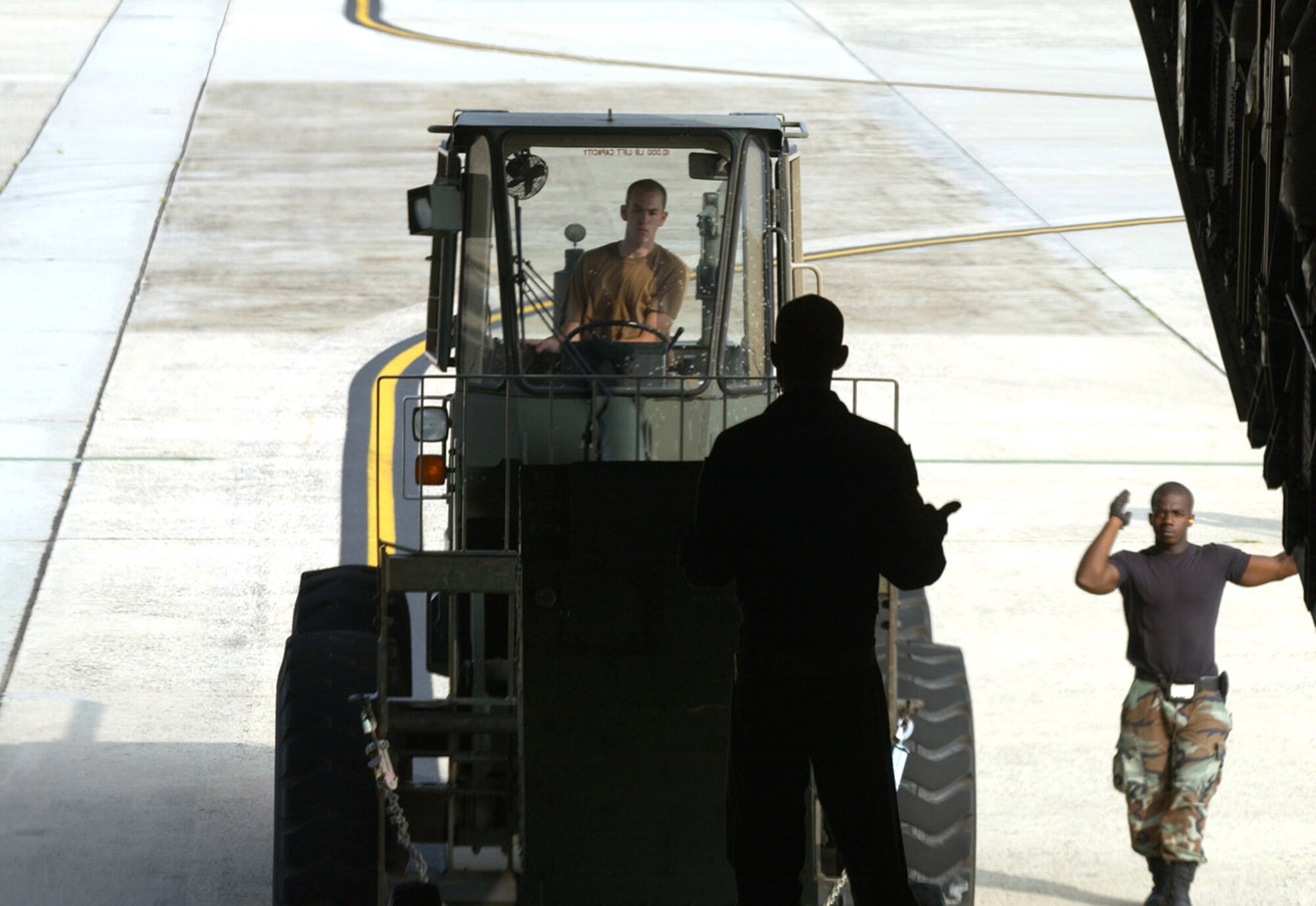 MCGUIRE AIR FORCE BASE, N.J. -- Airmen with the 305th Aerial Port Squadron here load equipment onto a C-17 Globemaster III headed for the New Orleans airport Aug. 31 to assist in Hurricane Katrina relief efforts. Twenty-nine Airmen from McGuire's 621st Contingency Response Wing and 110,000 pounds of equipment departed here for the hurricane-devastated region.  (U.S. Air Force photo by Kenn Mann)