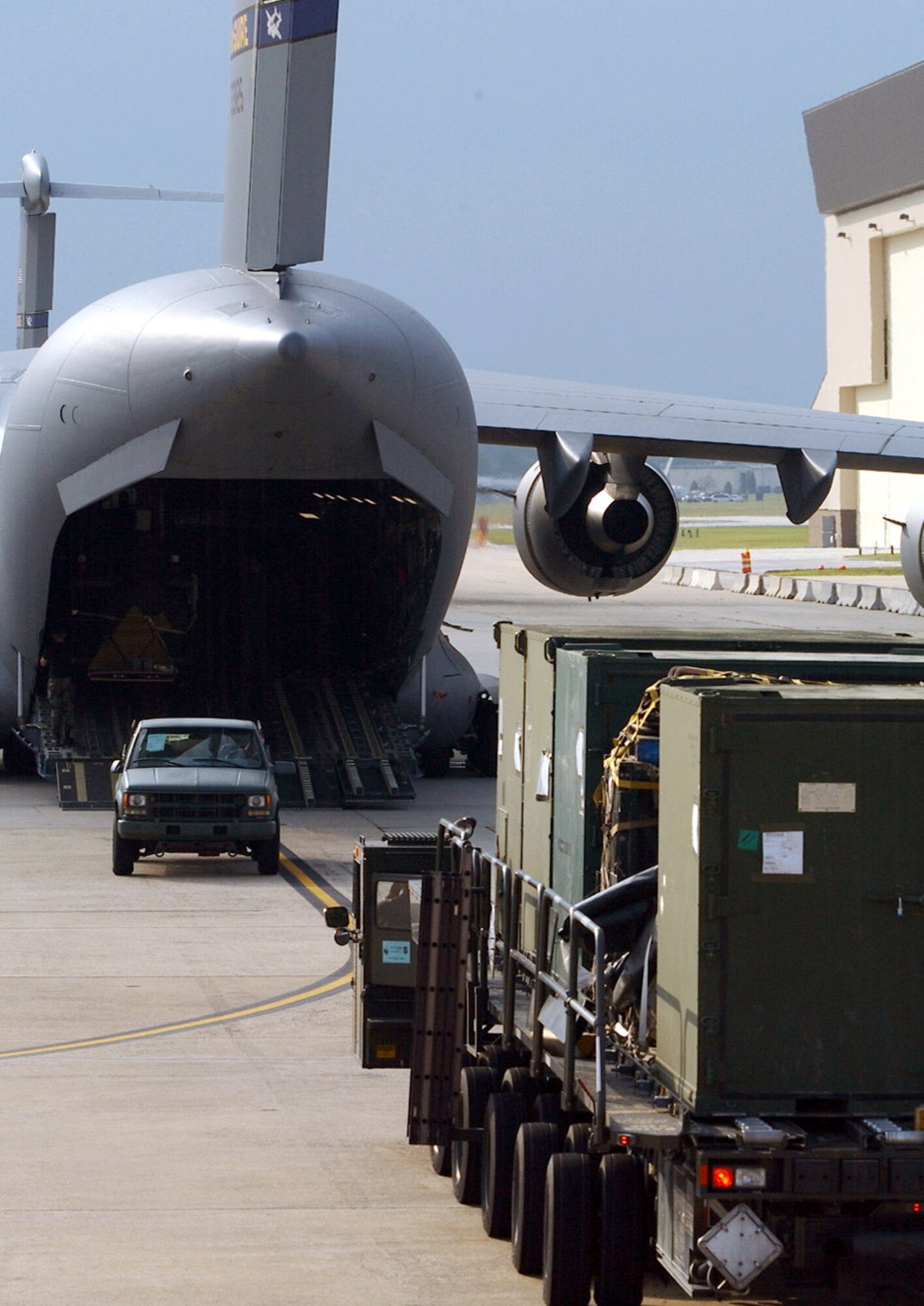 MCGUIRE AIR FORCE BASE, N.J. -- Airmen with the 305th Aerial Port Squadron here load equipment onto a C-17 Globemaster III headed for the New Orleans airport Aug. 31 to assist in Hurricane Katrina relief efforts. Twenty-nine Airmen from McGuire's 621st Contingency Response Wing and 110,000 pounds of equipment departed here for the hurricane-devastated region.  (U.S. Air Force photo by Kenn Mann)