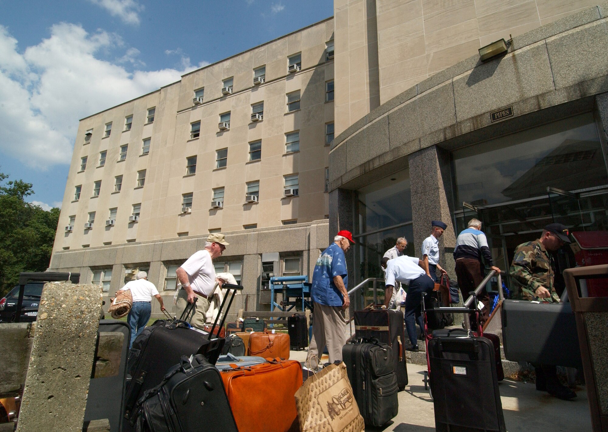 WASHINGTON -- Armed Forces Retiree's and some of the more than 100 military and civilian volunteers gather up luggage as they enter the Armed Forces Retirement Home here Sept. 1.  The veterans from Gulfport, Miss., were displaced by the effects of Hurricane Katrina and will be housed at the retirement home here until their facility can be repaired, which is estimated to take more than a year.  (U.S. Air Force photo by Staff Sgt. Amber K. Whittington)