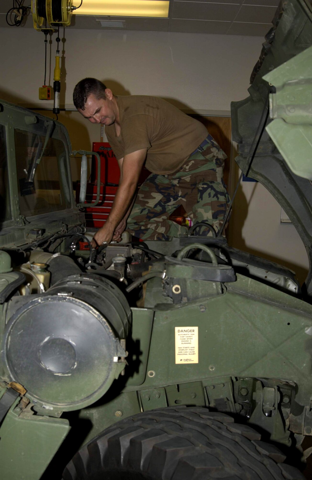 CAMP BEAUREGARD, La. - Airmen from the 122nd Air Support Operations Squadron here are helping coordinate Hurricane Katrina relief efforts in New Orleans.  Staff Sgt. Marco Youngblood is preparing a HUMVEE, equipped with a satellite radio, prior to sending it to New Orleans with tactical air controllers who are assisting various agencies provide help where it is needed.  Sergeant Youngblood is a squadron vehicle maintenance technician here.  (U.S. Air Force photo by Tech Sgt. Don Nelson)
