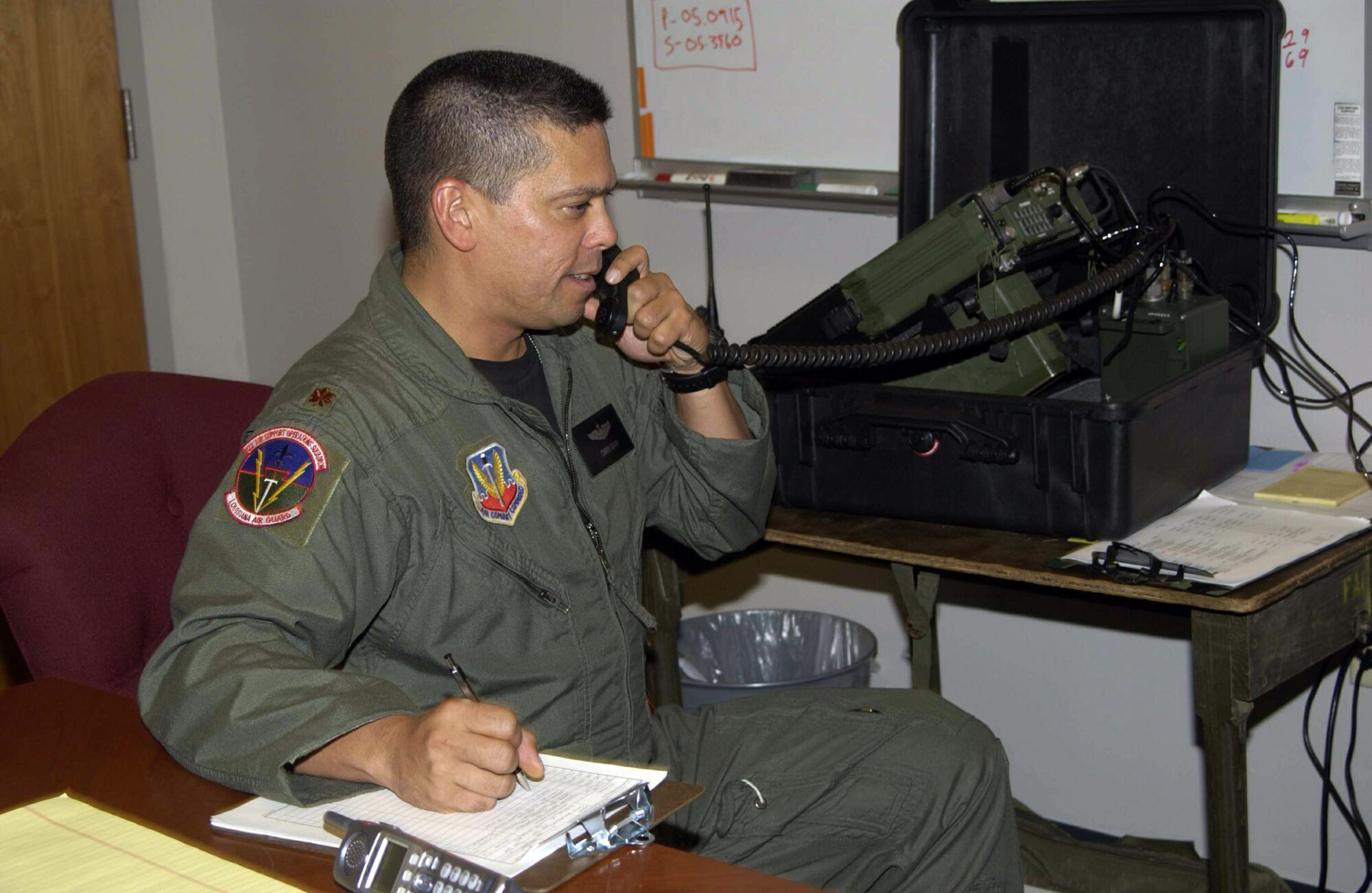 CAMP BEAUREGARD, La. - Airmen from the 122nd Air Support Operations Squadron here are helping coordinate Hurricane Katrina relief efforts in New Orleans.  Maj. Chris Gavin is operating a satellite radio from a command center communicating with tactical air controllers who are assisting various agencies provide help where it is needed.  Maj. Gavin is a squadron air liaison officer here.  (U.S. Air Force photo by Tech. Sgt. Don Nelson)