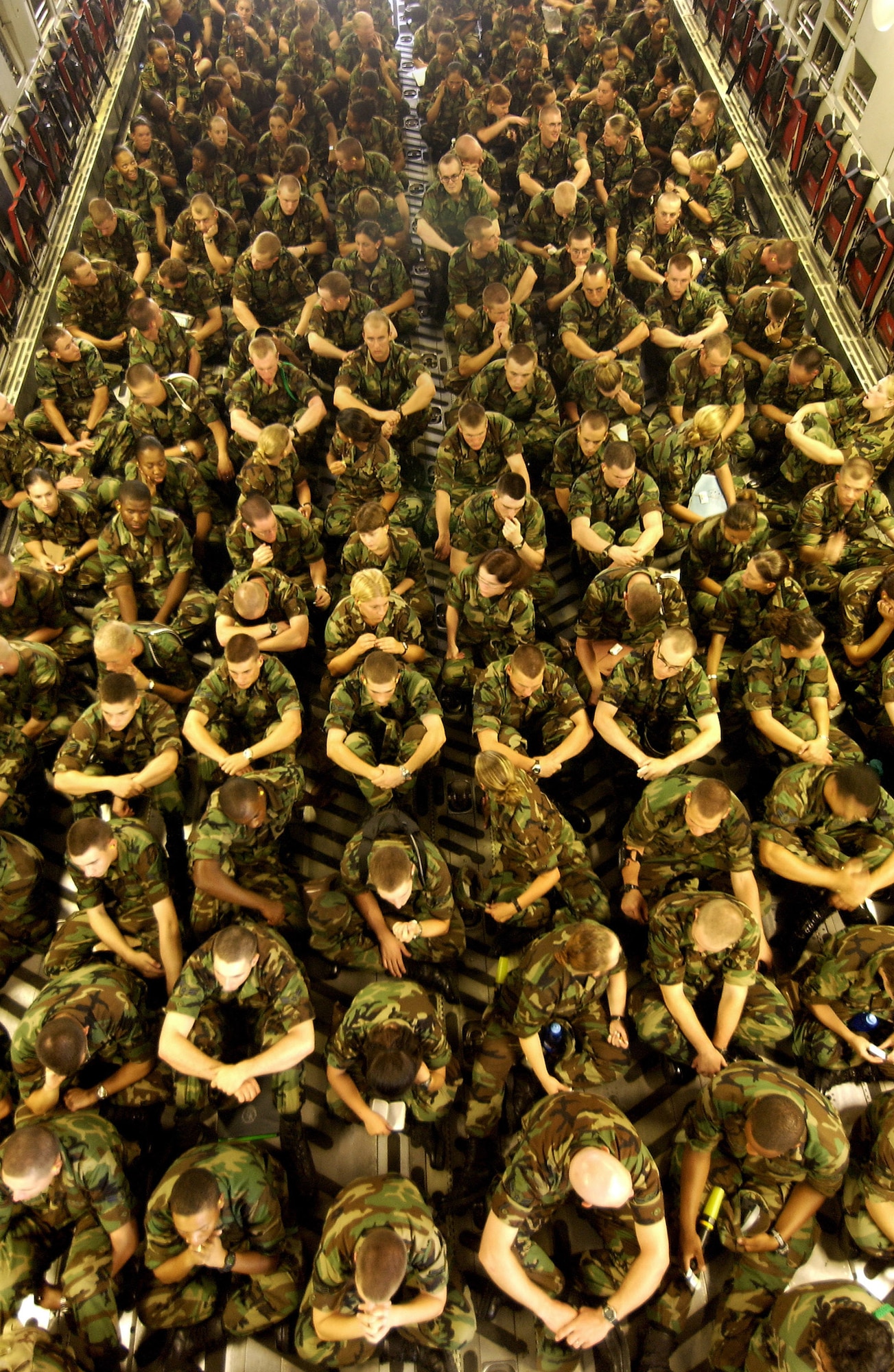 KEESLER AIR FORCE BASE, Miss. -- Students with the 332nd and 335th Training Squadrons here prepare to be evacuated to Sheppard Air Force Base, Texas, aboard a C-17 Globemaster III from the 58th Airlift Squadron, Altus AFB, Okla., Sept. 1. More than 2400 students and non essential personnel will be evacuated from Keesler because of Hurricane Katrina's aftermath.  (U.S. Air Force photo by Tech. Sgt. Mike Buytas)