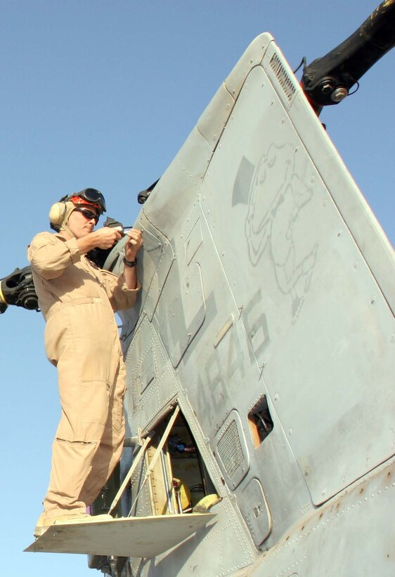 Capt. Sean Ducker, an avionics officer and pilot with Marine Medium Helicopter Squadron 764, prepares his CH-46 helicopter for take off prior to a mission.  HMM-764 boasts one of the most experienced pilot rosters in the Marine Corps, despite their reserve status.