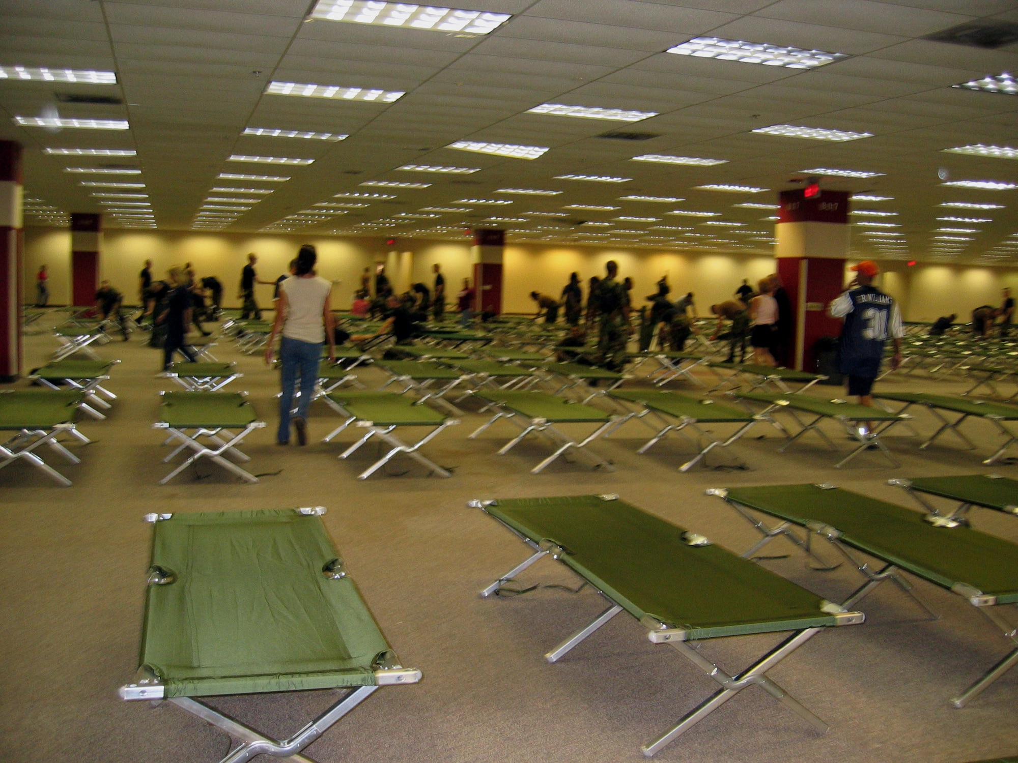 SAN ANTONIO -- Two hundred Airmen from nearby Lackland Air Force Base helped other volunteers set up about 2,500 cots and tear down modular office furniture in a 350,000 square foot building. The building will be used for people displaced by Hurricane Katrina.  (U.S. Air Force photo by Tech. Sgt. J.C. Woodring)