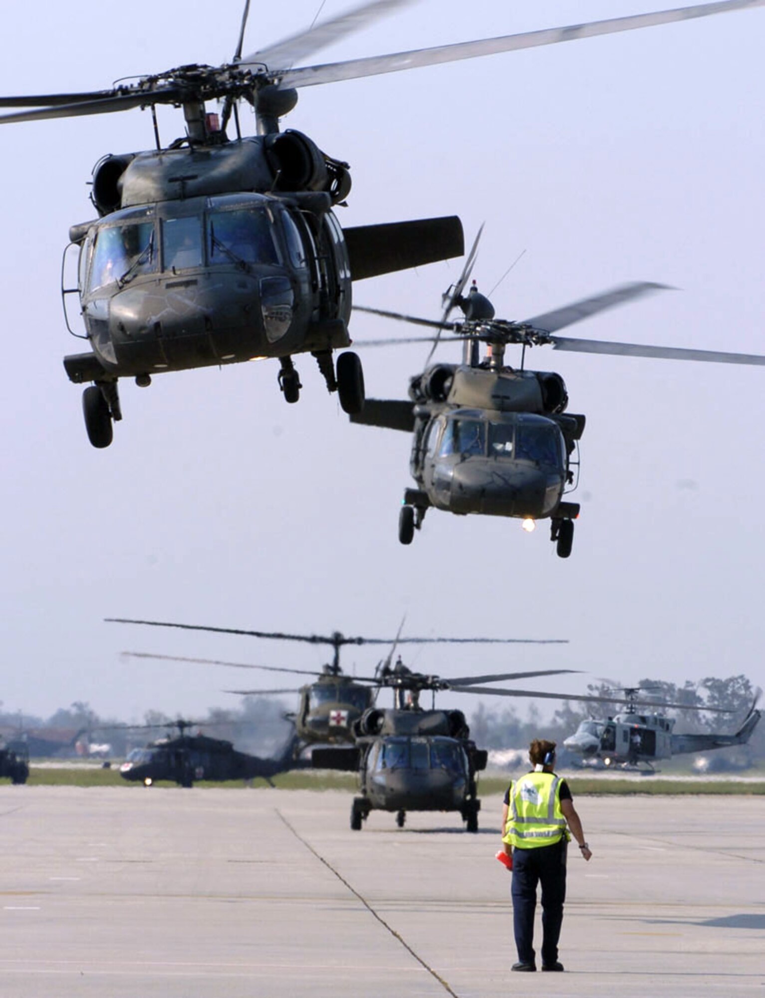 NEW ORLEANS -- Army and Air Force rescue helicopters depart on their next mission Sept. 2.  They are part of a massive operation to evacuate victims in the wake of Hurricane Katrina.  (U.S. Air Force photo by Master Sgt. Jack Braden)