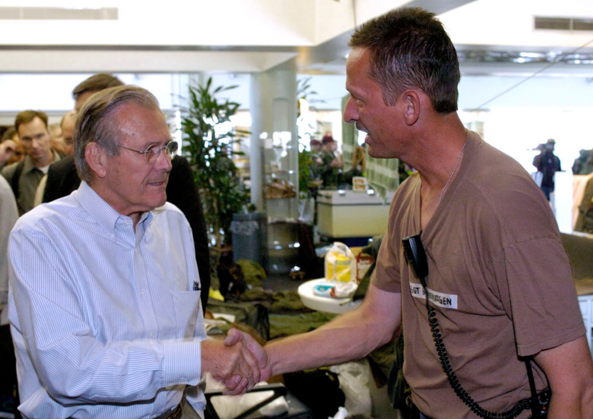 LOUIS ARMSTRONG NEW ORLEANS INTERNATIONAL AIRPORT, La. -- Secretary of Defense Donald Rumsfeld thanks Staff Sgt. W. Lance Boekenoogen for his efforts during the hurricane evacuation.  Sergeant Bokenoogen is assigned to the 152nd Medical Group in Reno, Nev.  (U.S. Air Force photo by Master Sgt Jack Braden)