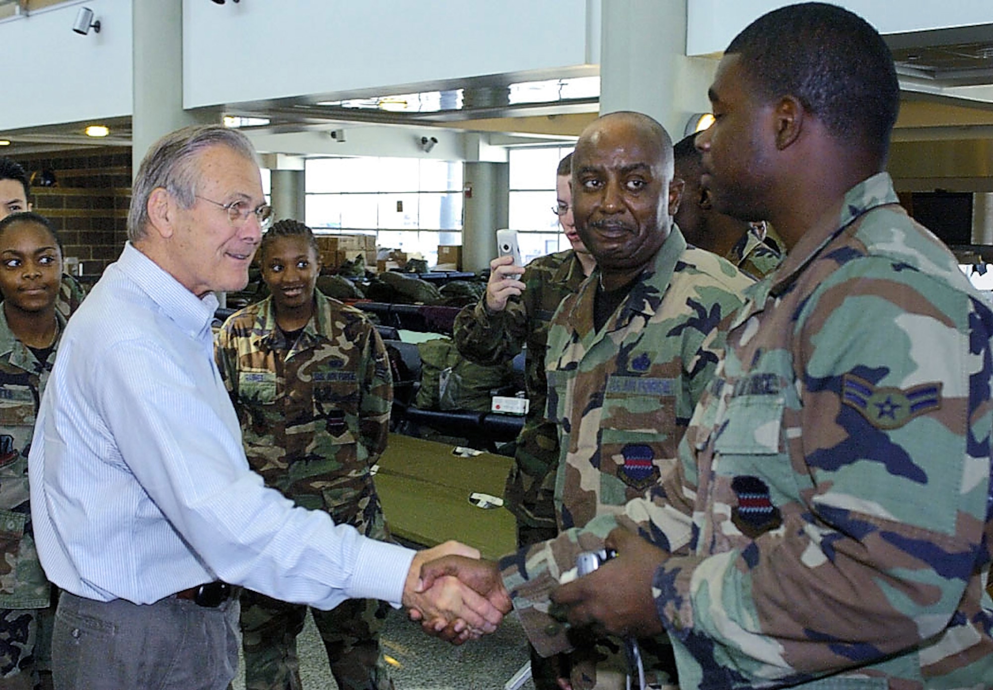 LOUIS ARMSTRONG NEW ORLEANS INTERNATIONAL AIRPORT, La. -- Secretary of Defense Donald Rumsfeld thanks Airman 1st Class David McAlpine  for his efforts during hurricane evacuation. (U.S. Air Force photo by Master Sgt Jack Braden)