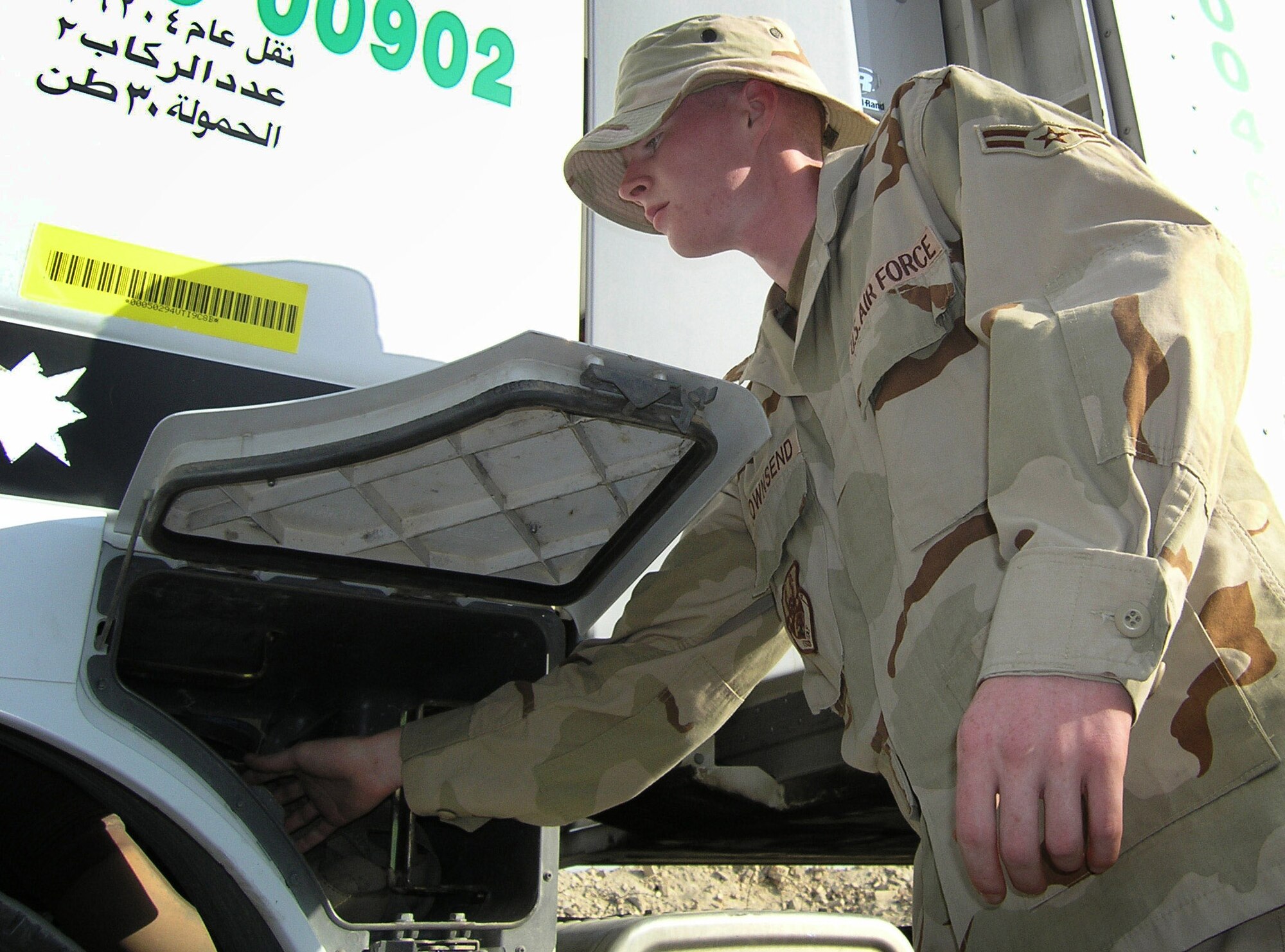 ALI BASE, Iraq -- Airman 1st Class Michael Townsend volunteers to search a vehicle at the 407th Expeditionary Security Forces Squadron's visitor control center here.  The center's workers are the first line of defense against terrorist acts occurring here.  Airman Townsend has volunteered three times to screen vehicles to protect the more than 9,000 U.S. servicemembers and coalition forces here.  He is assigned to the 407th Expeditionary Operations Support Squadron and is deployed from Mountain Home Air Force Base, Idaho.  (U.S. Air Force photo by Tech. Sgt. Melissa Phillips)