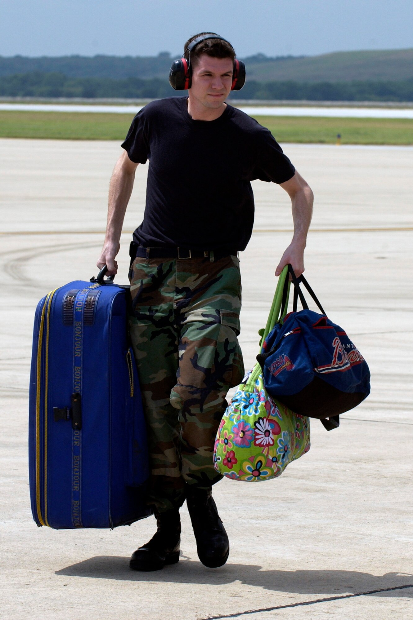 LACKLAND AIR FORCE BASE, Texas -- Senior Airman Eric Knug unloads luggage from a C-9 Nightingale aircraft that brought Hurricane Katrina evacuees here from New Orleans Sept. 3.  Evacuees are being inprocessed and given a medical checkup, fed and put into temporary shelters.  Airman Knug is assigned to the 37th Logistics Readiness Squadron. (U.S. Air Force photo by Tech. Sgt. Mark Borosch)