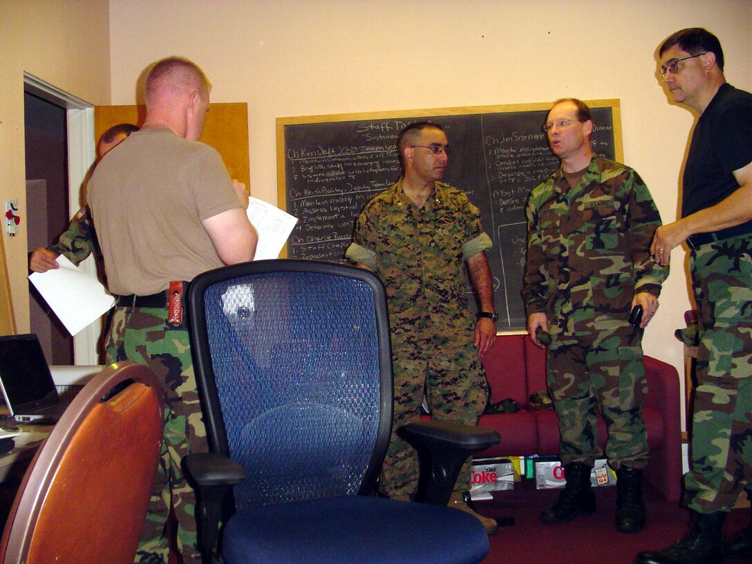 Army Cpl. Derek A. Marinaro, a team leader with the 109th Mechanized Infantry, uses sign language to communicate with his parents during a video teleconferencing session.  Marinaro's parents are deaf, and his inability to talk with them over phone made this the first time he had communicated with his parents since he arrived in Iraq six weeks ago.  The video teleconference was made possible by the Freedom Calls Foundation, a nonprofit organization dedicated to promoting better communication between deployed service members and their loved ones.