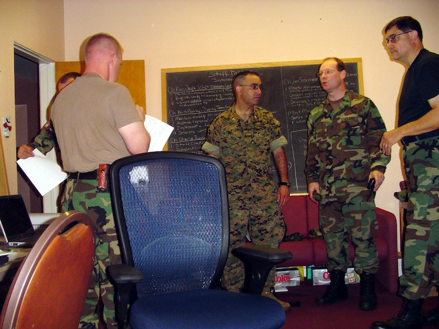 Army Cpl. Derek A. Marinaro, a team leader with the 109th Mechanized Infantry, uses sign language to communicate with his parents during a video teleconferencing session. Marinaro's parents are deaf, and his inability to talk with them over phone made this the first time he had communicated with his parents since he arrived in Iraq six weeks ago. The video teleconference was made possible by the Freedom Calls Foundation, a nonprofit organization dedicated to promoting better communication between deployed service members and their loved ones.