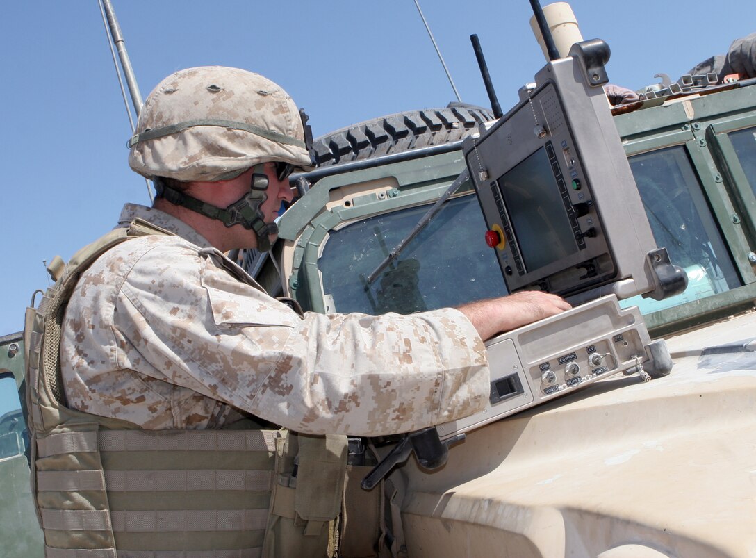 Sgt. Kristopher B. Hocking, technician, Explosive Ordnance Disposal, 8th Engineer Support Battalion, 2nd Force Service Support Group (FWD), navigates a robot using a computer here Sept. 5. The Marines of EOD have a very positive outlook on their job, and always keep their objective in mind.