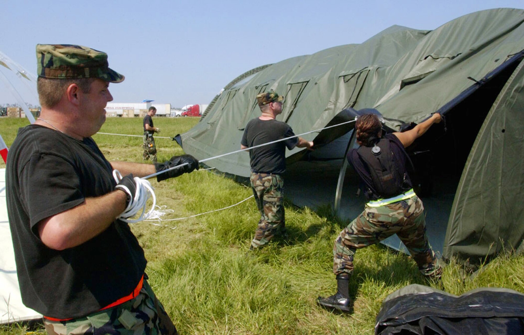 NEW ORLEANS -- Airman erect tents at Louis Armstrong International Airport here Sept. 4.  The tents were flown in from the 49th Materiel Maintenance Group at Holloman Air Force Base, N.M., to house workers supporting the Hurricane Katrina relief effort.  (U.S. Air Force photo by Master Sgt. Jack Braden)