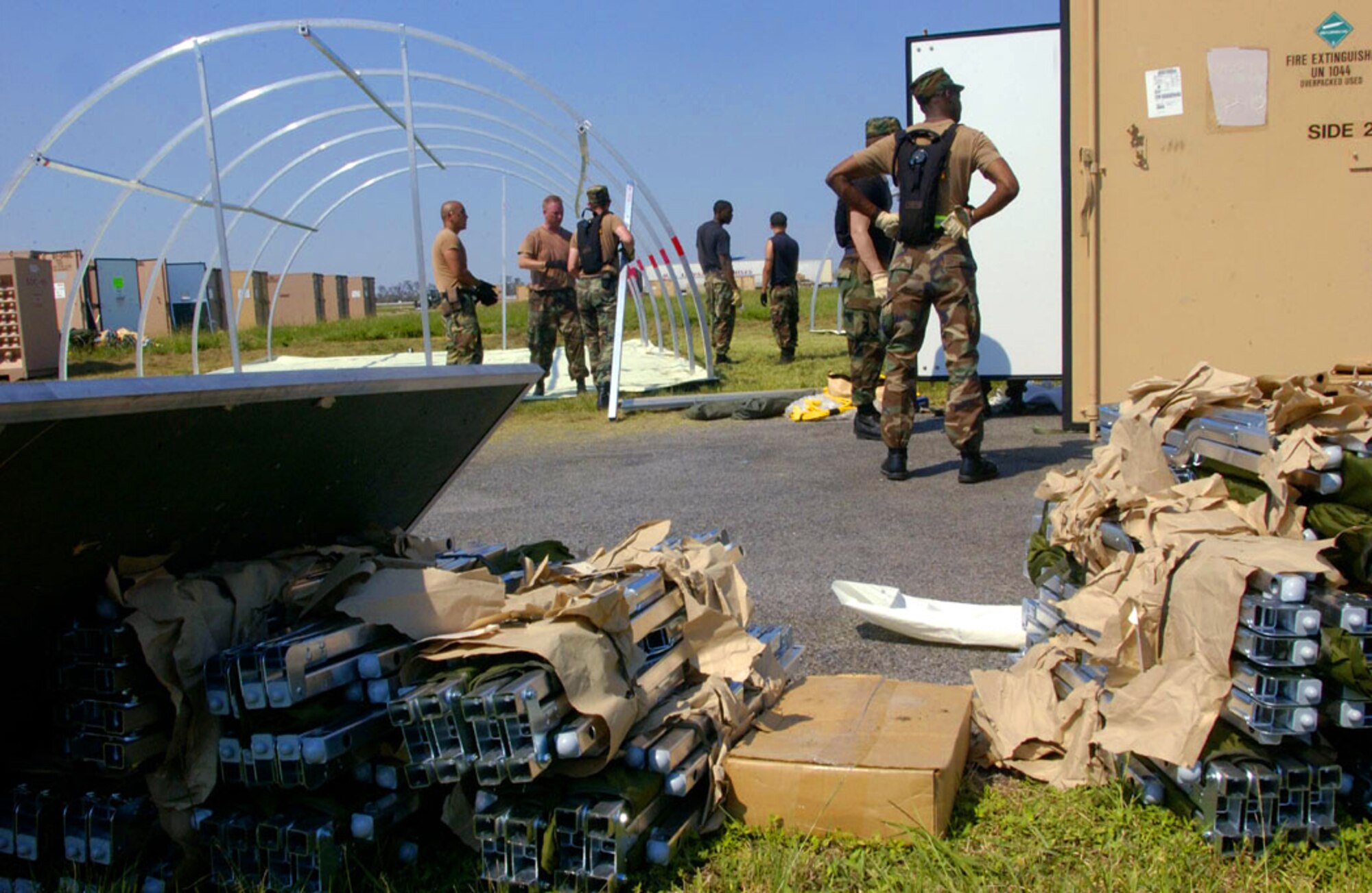 NEW ORLEANS -- Airman erect tents at Louis Armstrong International Airport here Sept. 4.  The tents were flown in from the 49th Materiel Maintenance Group at Holloman Air Force Base, N.M., to house workers supporting the Hurricane Katrina relief effort.  (U.S. Air Force photo by Master Sgt. Jack Braden)