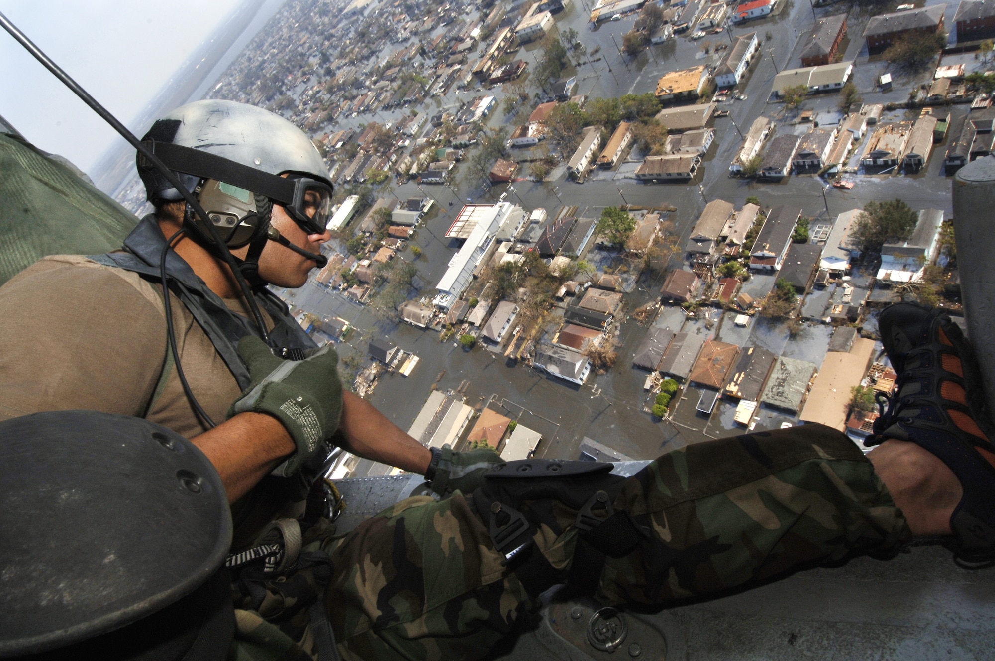 NEW ORLEANS -- Tech. Sgt. Lem Torres surveys houses Sept. 2 looking for victims of Hurricane Katrina.  Sergeant Torres is a pararescueman in the 38th Rescue Squadron, Moody Air Force Base, Ga.  (U.S. Air Force photo by Staff Sgt. Manuel J. Martinez)