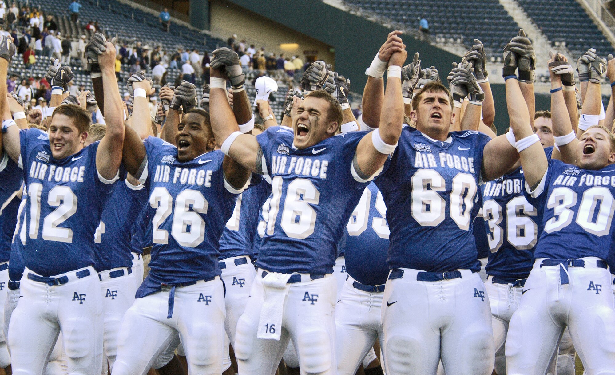SEATTLE -- Air Force Academy Falcon players (left to right) Scott Eberle, 12; Jared Baxley, 26; Adam Fitch, 16; Stuart Perlow, 60; and Donny Heaton, 30; celebrate their 20-17 season opening win over the University of Washington Huskies Sept. 3 at Qwest Field in Seattle.  (U.S. Air Force photo by 2nd Lt. John Ross)