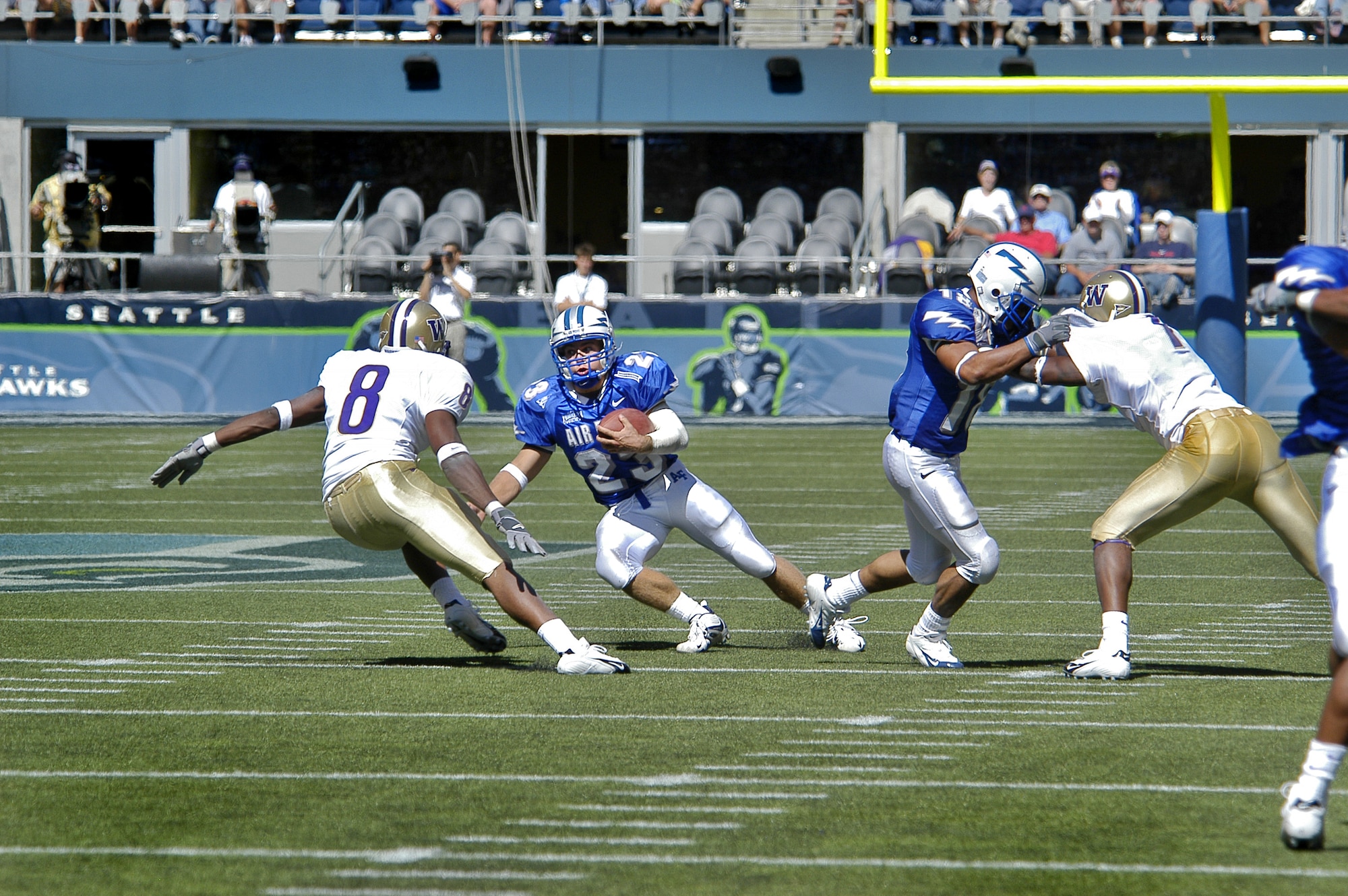 SEATTLE -- Air Force Academy Falcon halfback Chad Hall eyes University of Washington free safety Dashon Goldson in the open field as Air Force's Justin Handley blocks a defender.  The Cadets defeated the Huskies in the season opener for both teams, 20-17. (U.S. Air Force photo by 2nd Lt. John Ross)