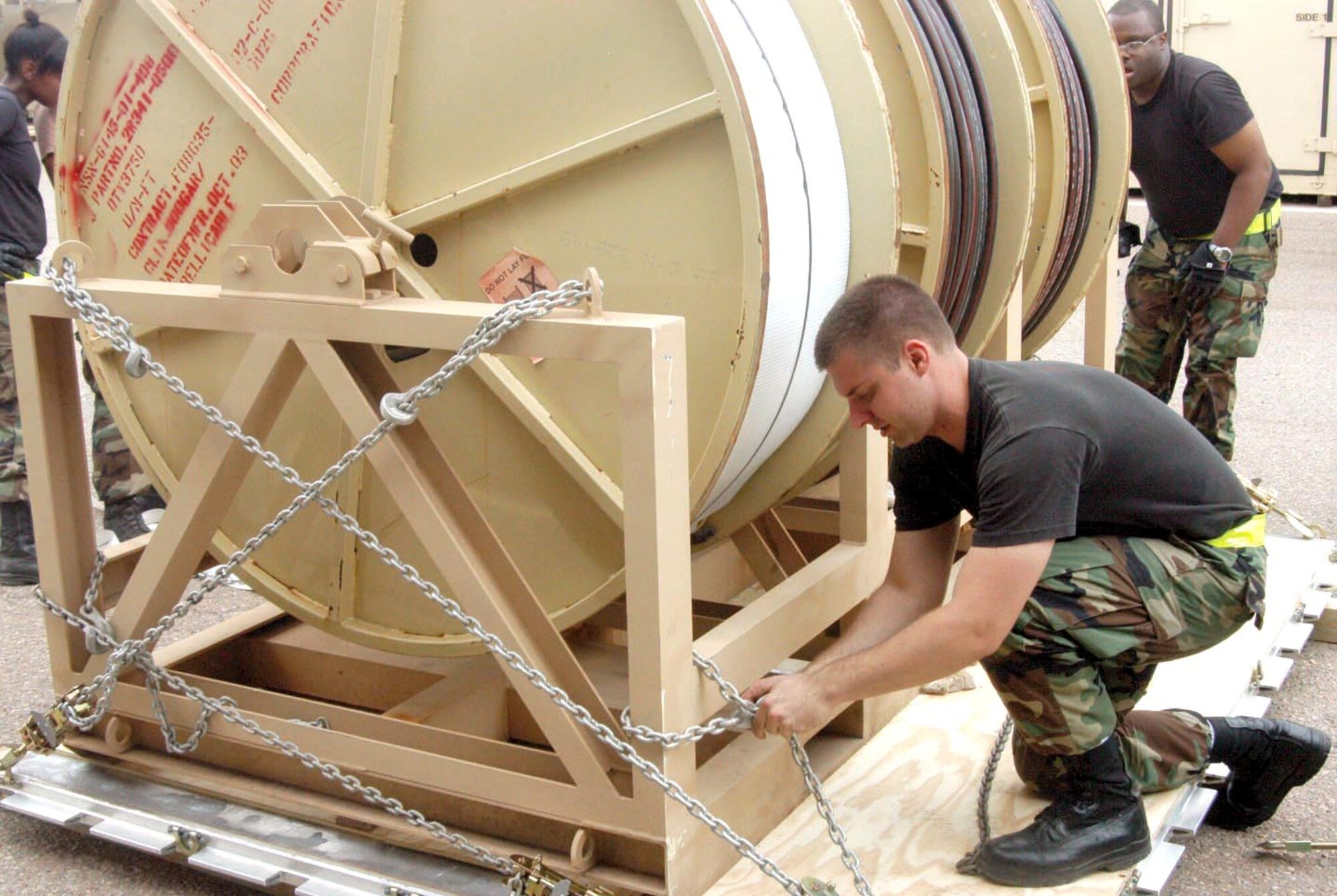 HOLLOMAN AIR FORCE BASE, N.M. -- Staff Sgt. Michael Lyons secures electrical cable spools to a pallet before it is loaded on a C-5 Galaxy aircraft here for shipment to the Gulf Coast.  Sergeant Lyons is a crew chief with the 8th Aircraft Maintenance Unit.  (U.S. Air Force photo by Tech. Sgt. Ray Bowden)