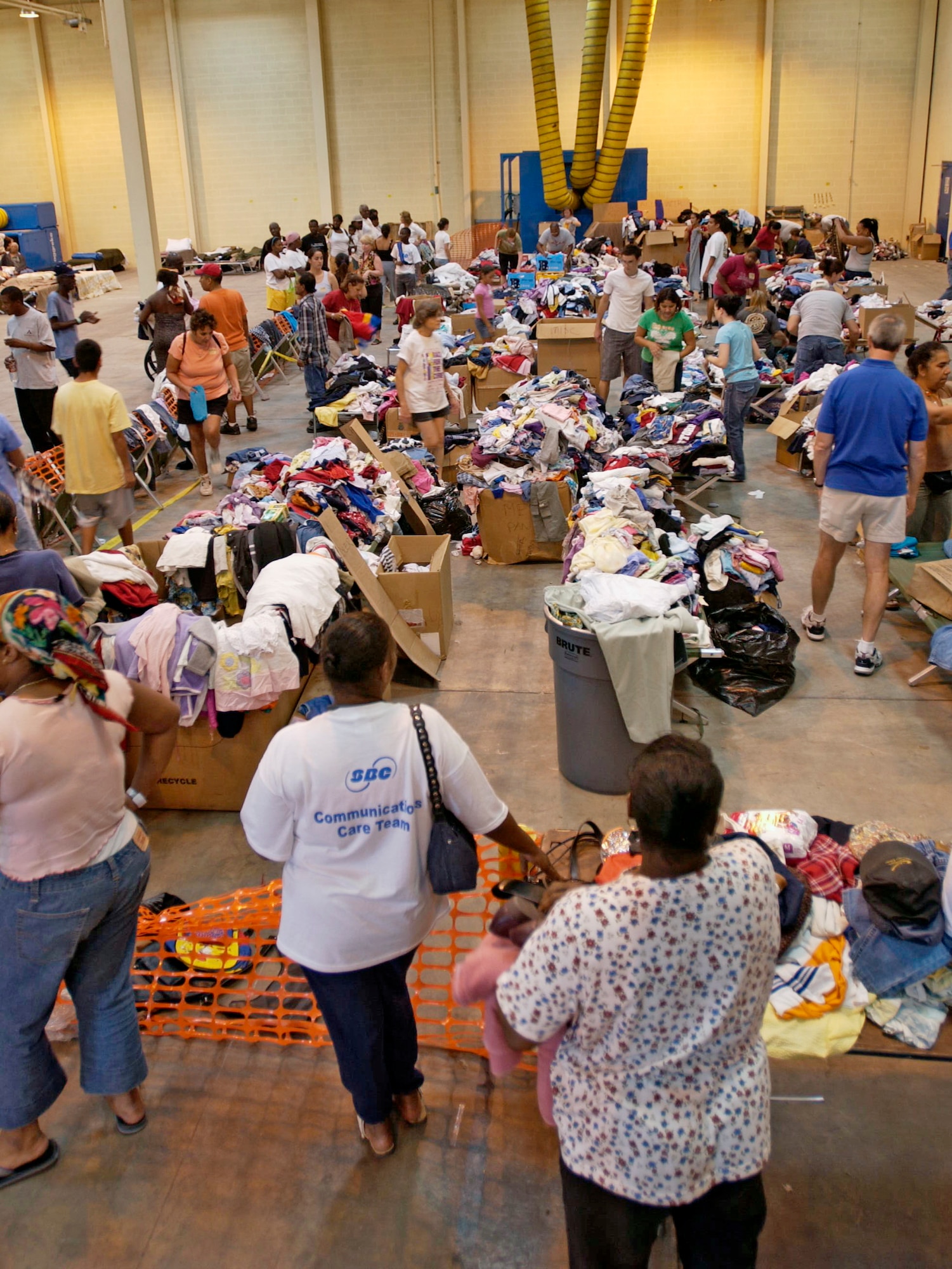 SAN ANTONIO - Gulf Coast evacuees sort through donated items here.  The evacuees were inprocessed, given a medical checkup, fed and provided donated clothing and other personal needs. (U.S. Air Force photo by Tech. Sgt. Mark Borosch)