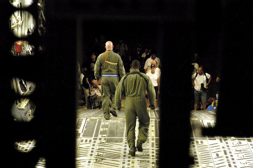 LOUIS ARMSTRONG NEW ORLEANS INTERNATIONAL AIRPORT, La. -- Airmen prepare to bring evacuees from New Orleans aboard a C-17 Globemaster III aircraft.  More than 140 evacuees, who are victims of flooding caused by Hurricane Katrina, were evacuated to Austin, Texas.  (U.S. Air Force photo by 1st Lt. Neil Senkowski)