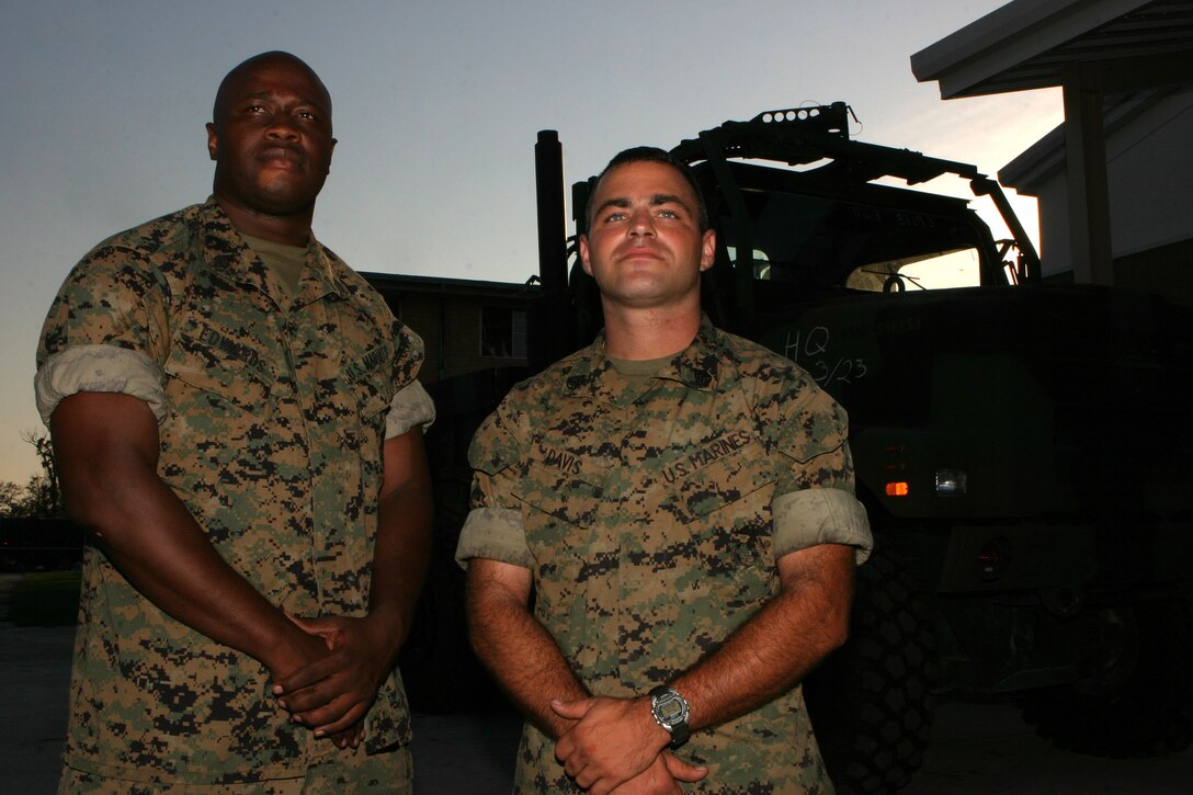 NAVAL AIR STATION NEW ORLEANS (Sept. 6, 2005) - Sgt. Lorenzo L. Edwards (left) and Staff Sgt. Matthew J. Davis, both inspector instructor staff for 3rd Battalion, 23rd Marine Regiment, volunteered to work with the air station's emergency operations center during Hurricane Katrina. Serving as the only Marines aboard the air station, Davis and Edwards supported area clean ups, relief conovys and assisted the 24th Marine Expeditionary Unit Command Element as they arrived here.
