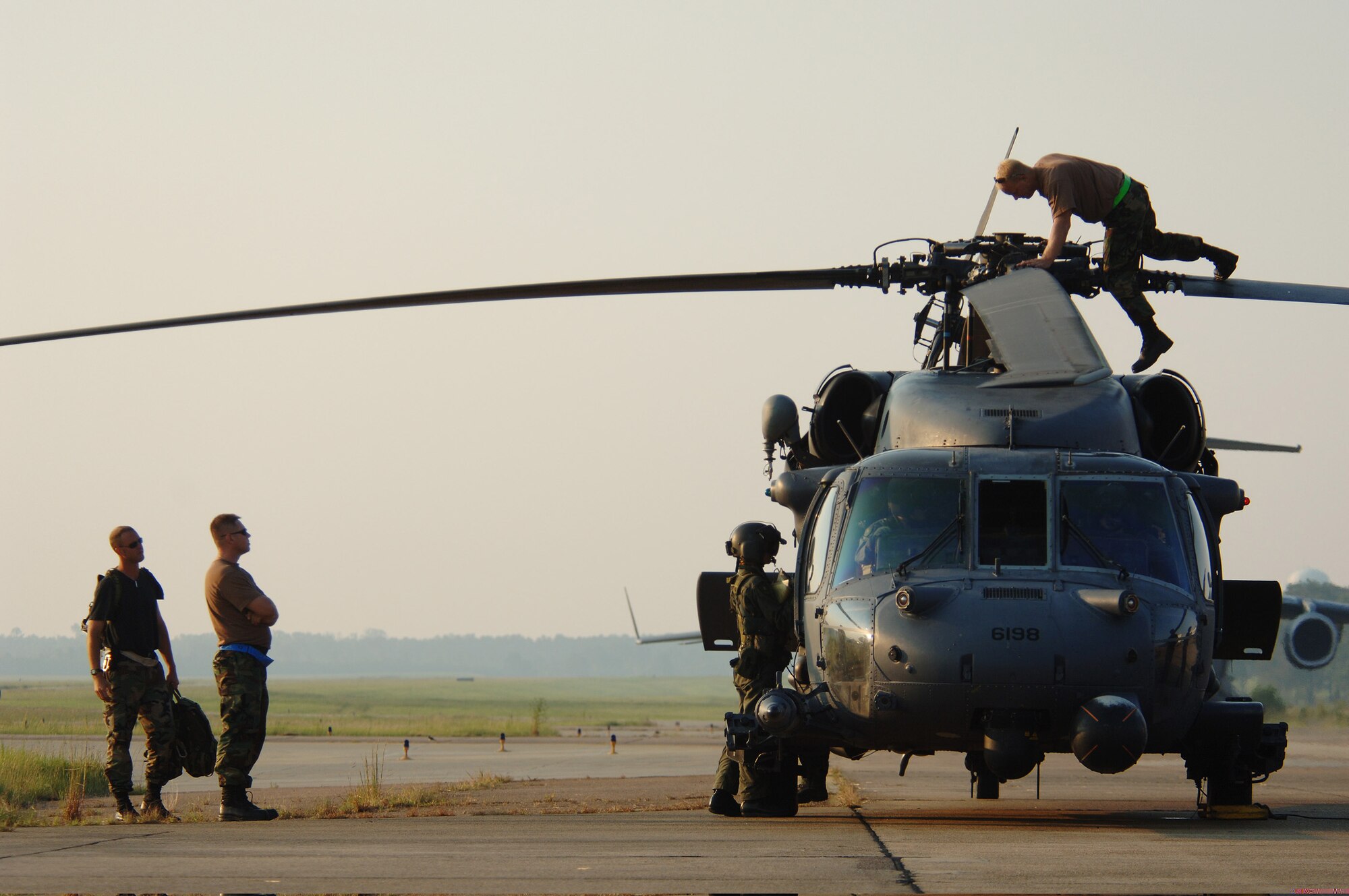 JACKSON, Miss. -- Maintenance crews work on an HH-60G Pave Hawk rescue helicopter after it broke before launching.  Aircrews from active and Reserve units are here working to rescue people trapped by the flood waters of Hurricane Katrina's destruction along the U.S. southern coast.  (U.S. Air Force photo by Master Sgt. Efrain Gonzalez)