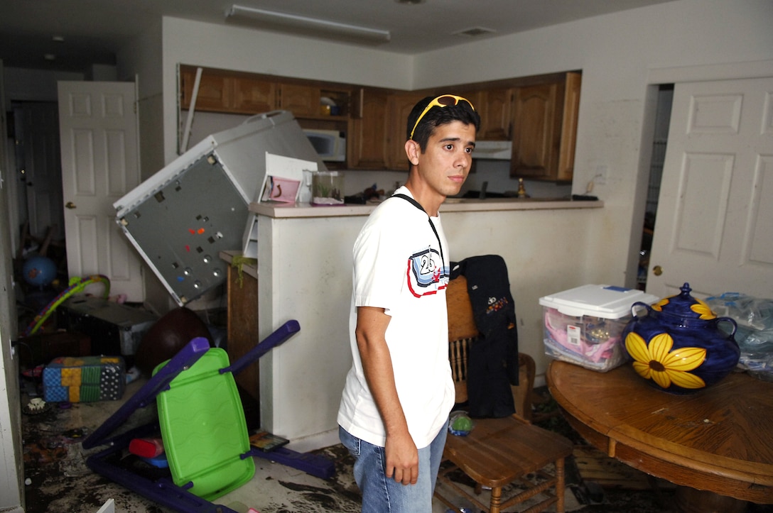 KEESLER AIR FORCE BASE, Miss. -- Staff Sgt. Jose Espola-Negron looks around his on-base house in disbelief.  Most of his belongings were ruined from flooding in the aftermath of Hurricane Katrina. Before returning here from Eglin Air Force Base, Fla., where his family evacuated to before the storm, the only information he had about his home was that it had taken in a lot of water. During the highest point of the flooding, more than 6 feet of water was in his home. Sergeant Espola-Negron is an air traffic control instructor with the 334th Training Readiness Squadron here. (U.S. Air Force photo by Joe Piccorossi)