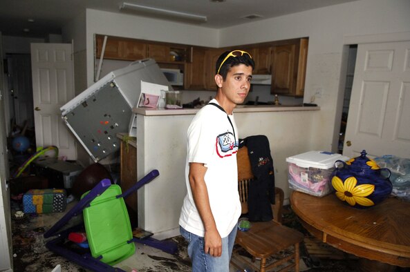 KEESLER AIR FORCE BASE, Miss. -- Staff Sgt. Jose Espola-Negron looks around his on-base house in disbelief.  Most of his belongings were ruined from flooding in the aftermath of Hurricane Katrina. Before returning here from Eglin Air Force Base, Fla., where his family evacuated to before the storm, the only information he had about his home was that it had taken in a lot of water. During the highest point of the flooding, more than 6 feet of water was in his home. Sergeant Espola-Negron is an air traffic control instructor with the 334th Training Readiness Squadron here. (U.S. Air Force photo by Joe Piccorossi)