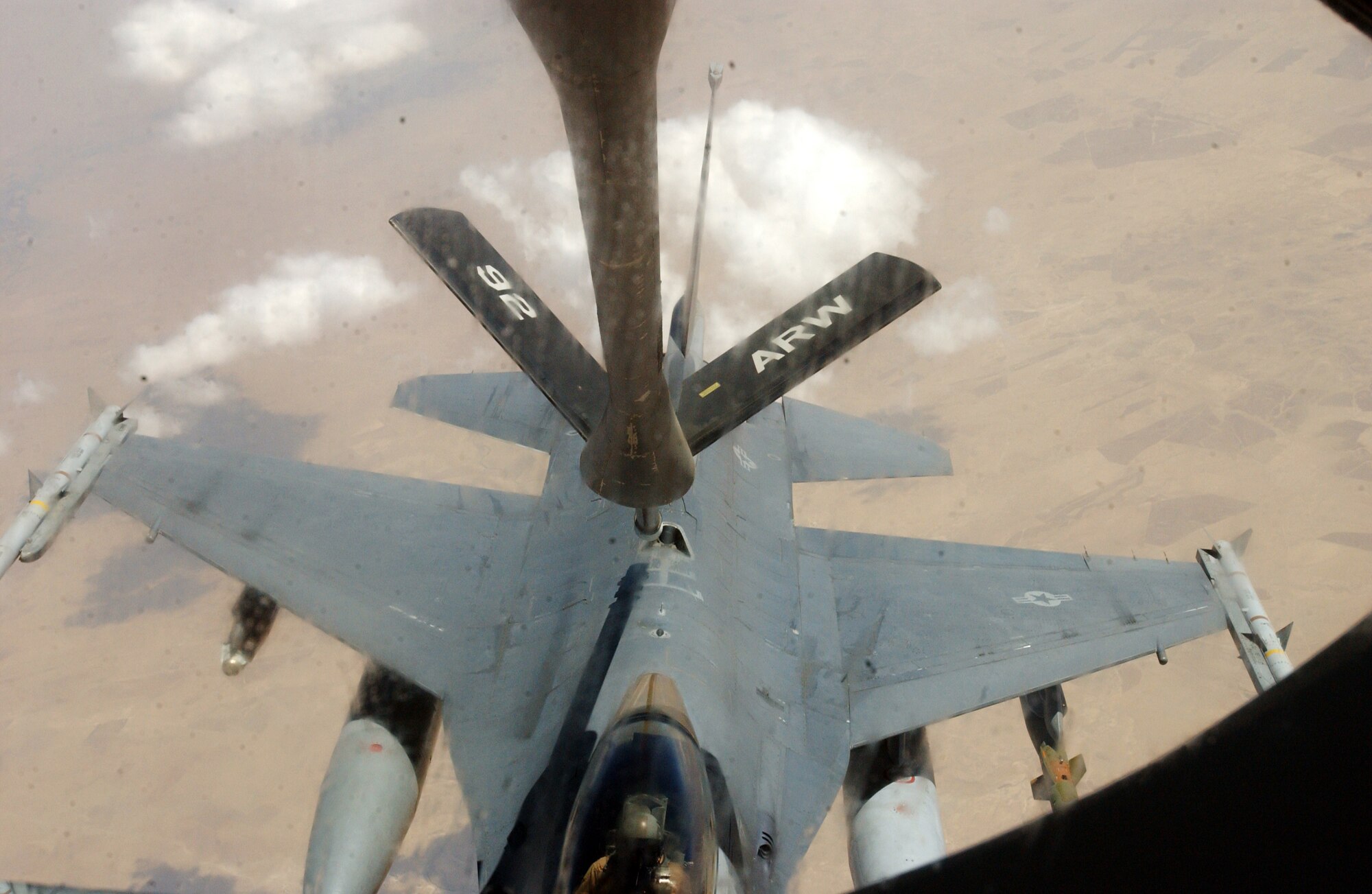 OVER IRAQ -- An F-16 Fighting Falcon moves into place behind a KC-135 Stratotanker.  The KC-135 is from the 92nd Air Refueling Wing at Fairchild Air Force Base, Wash., and the crew flying it is from McConnell AFB, Kan.  Thirty-five aircraft are refueled on an average day by coalition aircraft.  (U.S. Air Force photo by Staff Sgt. Justin Jacobs)