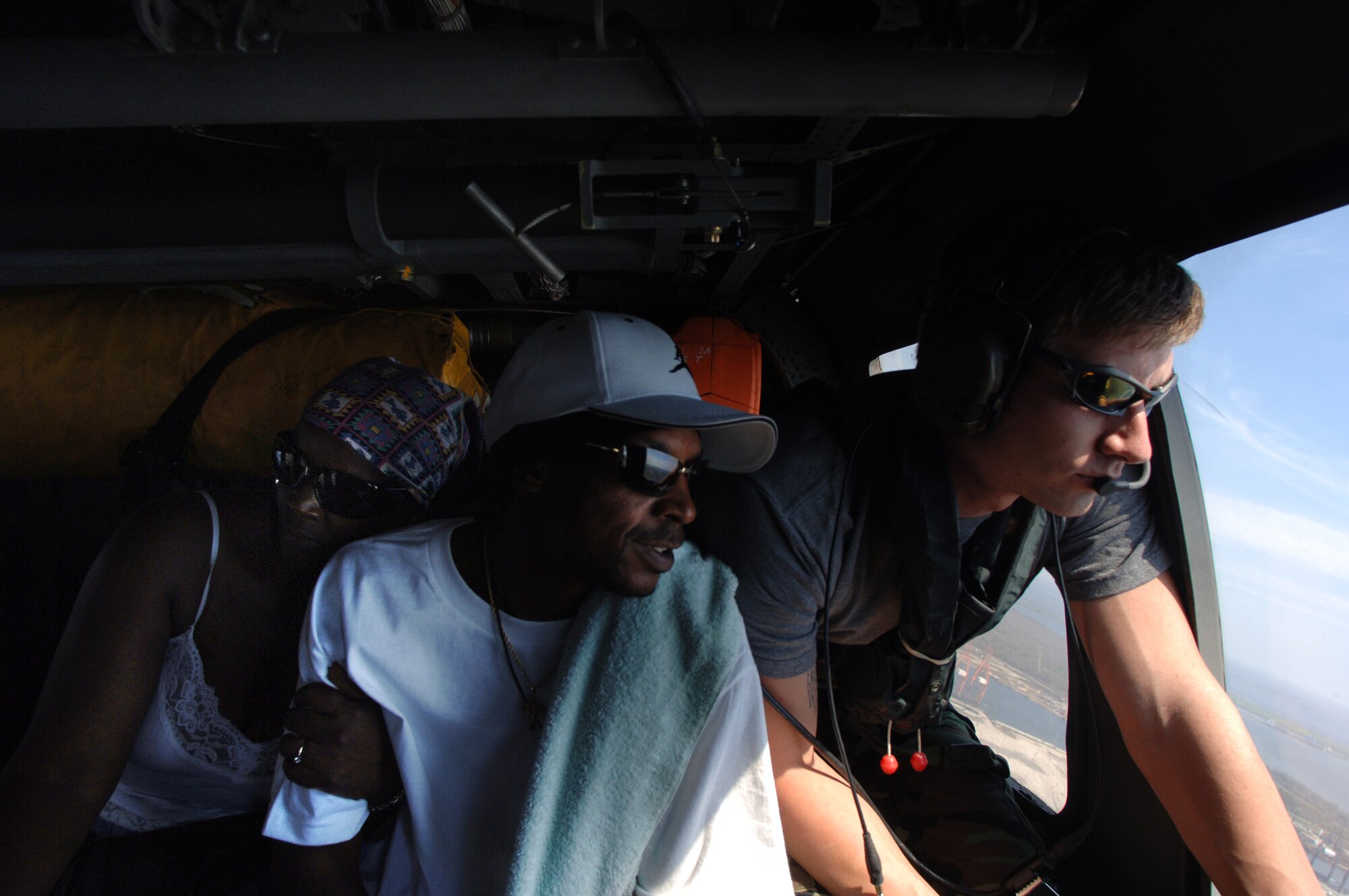 NEW ORLEANS -- Yasmine Lee Johnson clings to her husband, Clarence, as they are flown to Louis Armstrong New Orleans International Airport to join other evacuees being rescued from the flood waters of Hurricane Katrina's devastating aftermath.  The helicopter and crew are with the 347th Expeditionary Rescue Group operating out of Jackson, Miss.  (U.S. Air Force photo by Master Sgt. Efrain Gonzalez)