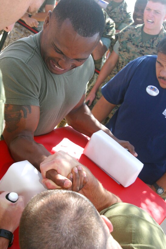 CAMP PENDLETON, Calif. (Sept. 8, 2005) - Sgt. Shannon R. Haynes (top), grits his teeth while trying to stay alive against Sgt. Thomas Ryan McMickle, during a match in the Commanding General's Cup Arm Wrestling Tournament. McMickle defeated Haynes and went on to win 1st place while Haynes finished 3rd.  (Official USMC photo by Cpl. Scott L. Eberle)