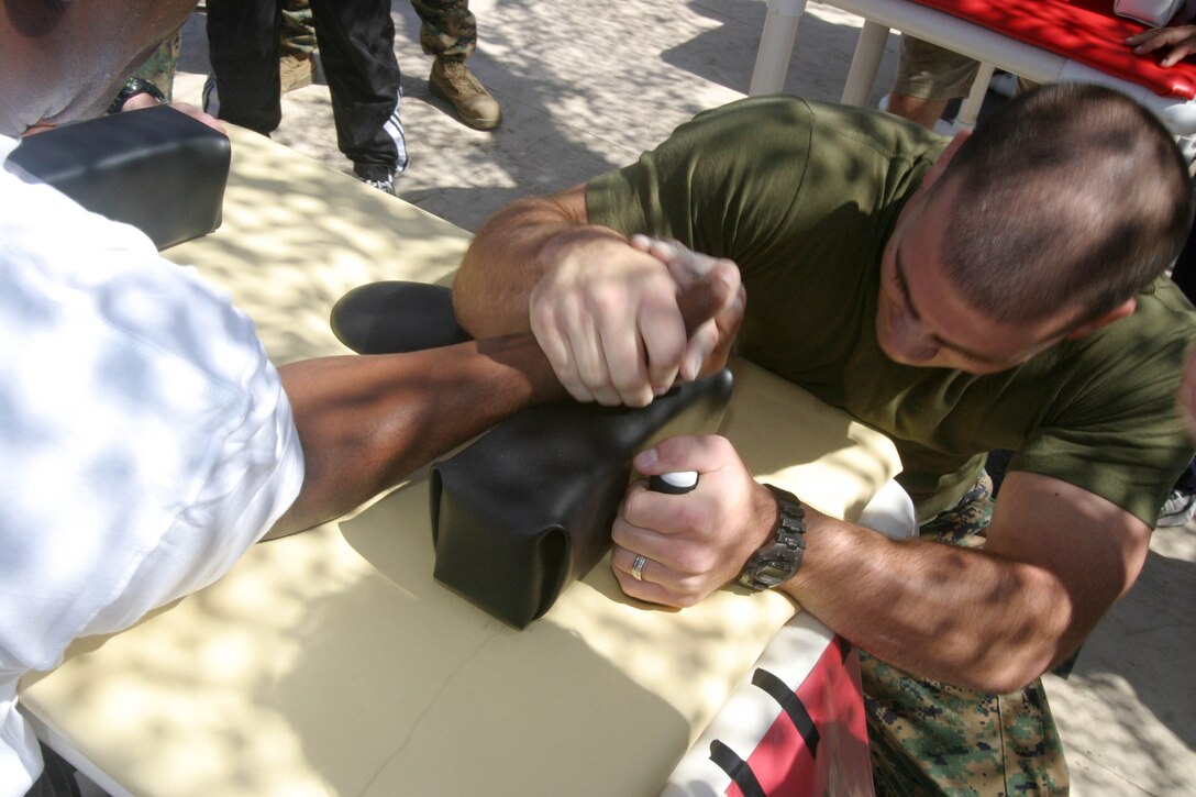 CAMP PENDLETON, Calif. (Sept. 8, 2005) - Sgt. Thomas Ryan McMickle, the assistant radio chief for the 15th Marine Expeditionary Unit, and Oak Harbor, Wash. native, defeats Gunnery Sgt. Martin Carnell in the championship match of the Commanding General's Cup Arm Wrestling Tournament.  (Official USMC photo by Cpl. Scott L. Eberle)