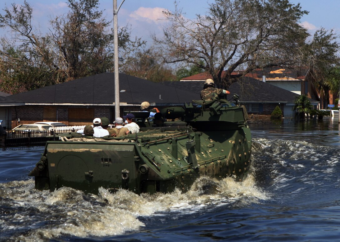 NEW ORLEANS (Sep. 8, 2005) - Amphibious vehicles and infantrymen serving with Special Purpose Marine Air Ground Task Force Katrina travel down the decimated streets of Orleans Parish conducting search and rescue operations. Some communities in the parish were at one point, under more than ten feet of water.::n::